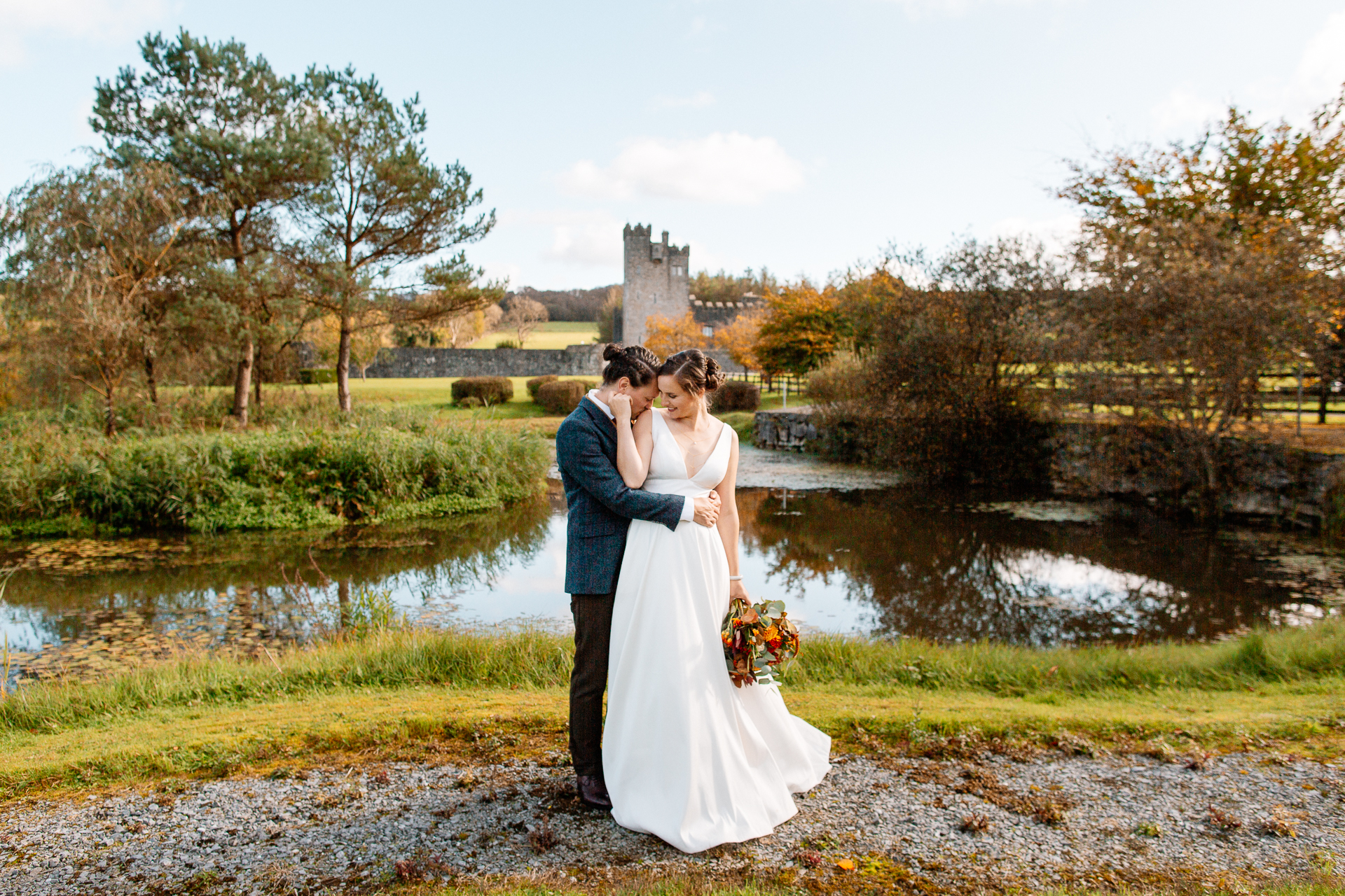 A man and woman kissing by a pond