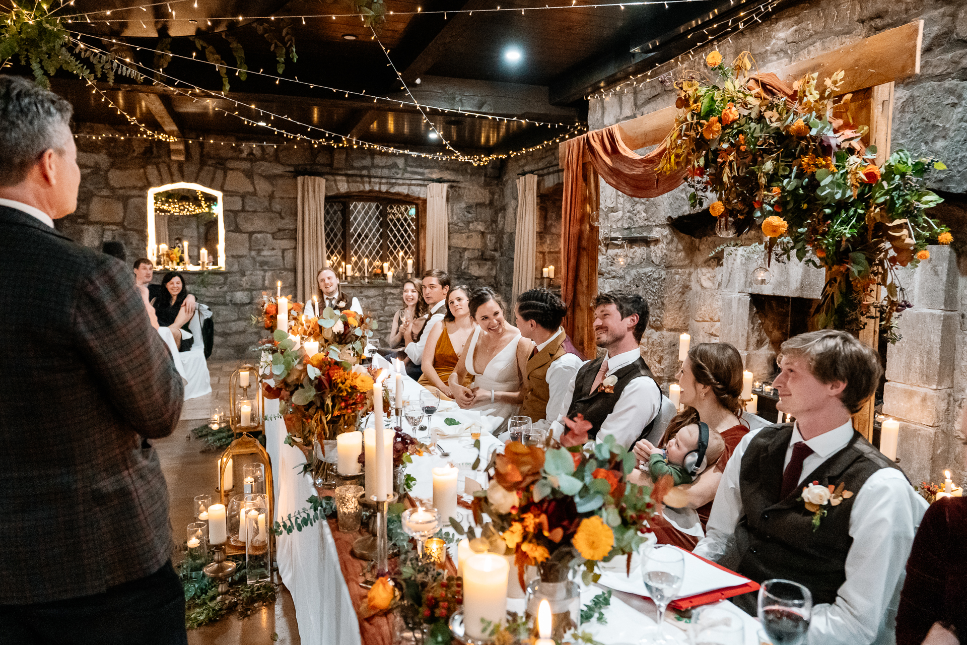 A group of people sitting at a table with flowers