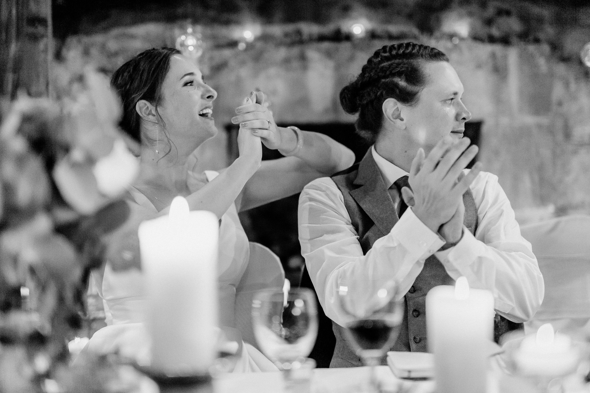 A man and woman sitting at a table with wine glasses