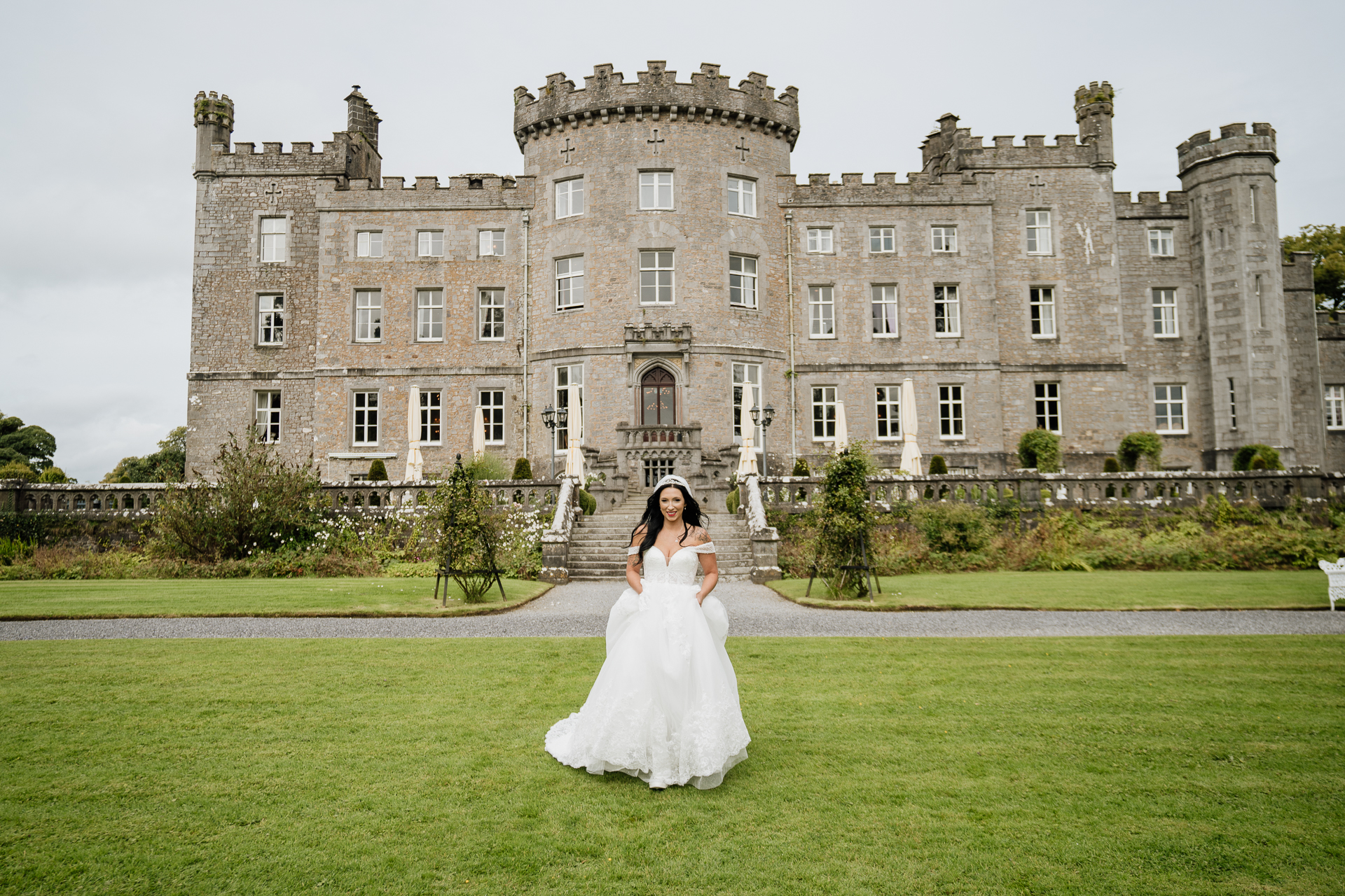 A person in a wedding dress in front of a large building