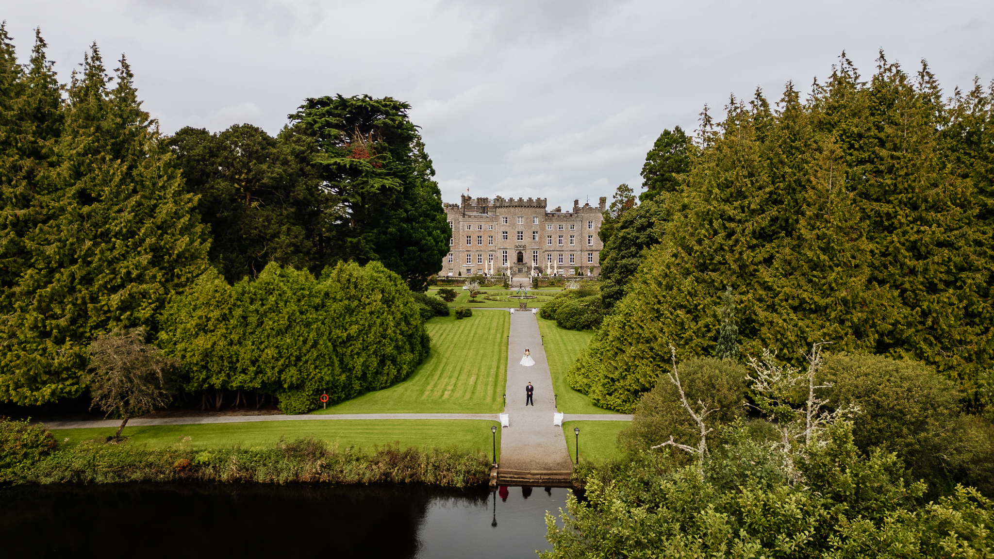 A large building with a lawn and trees around it