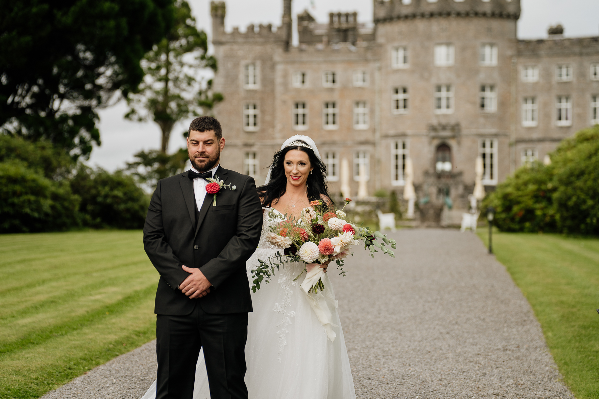 A man and woman posing for a picture in front of a building