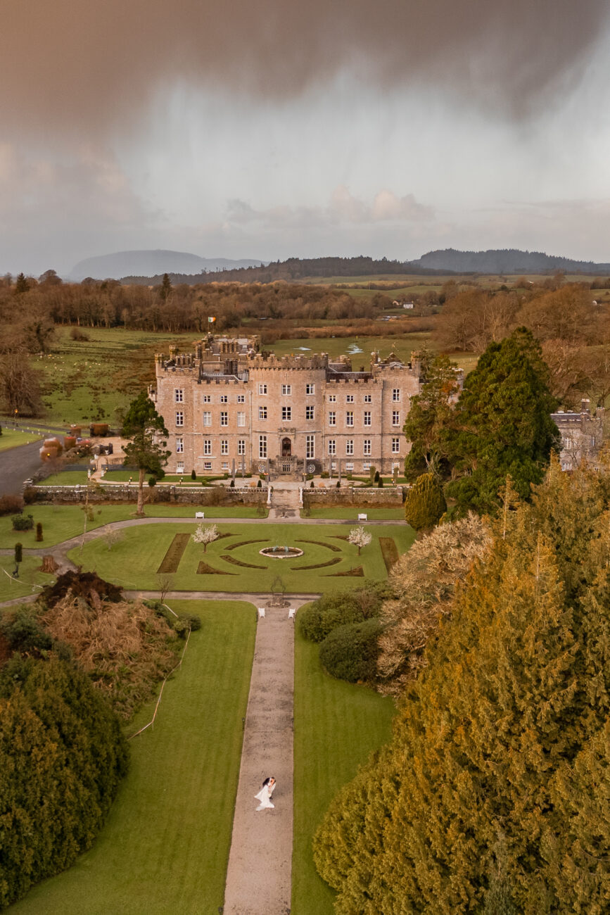 A large building with a lawn and trees in front of it