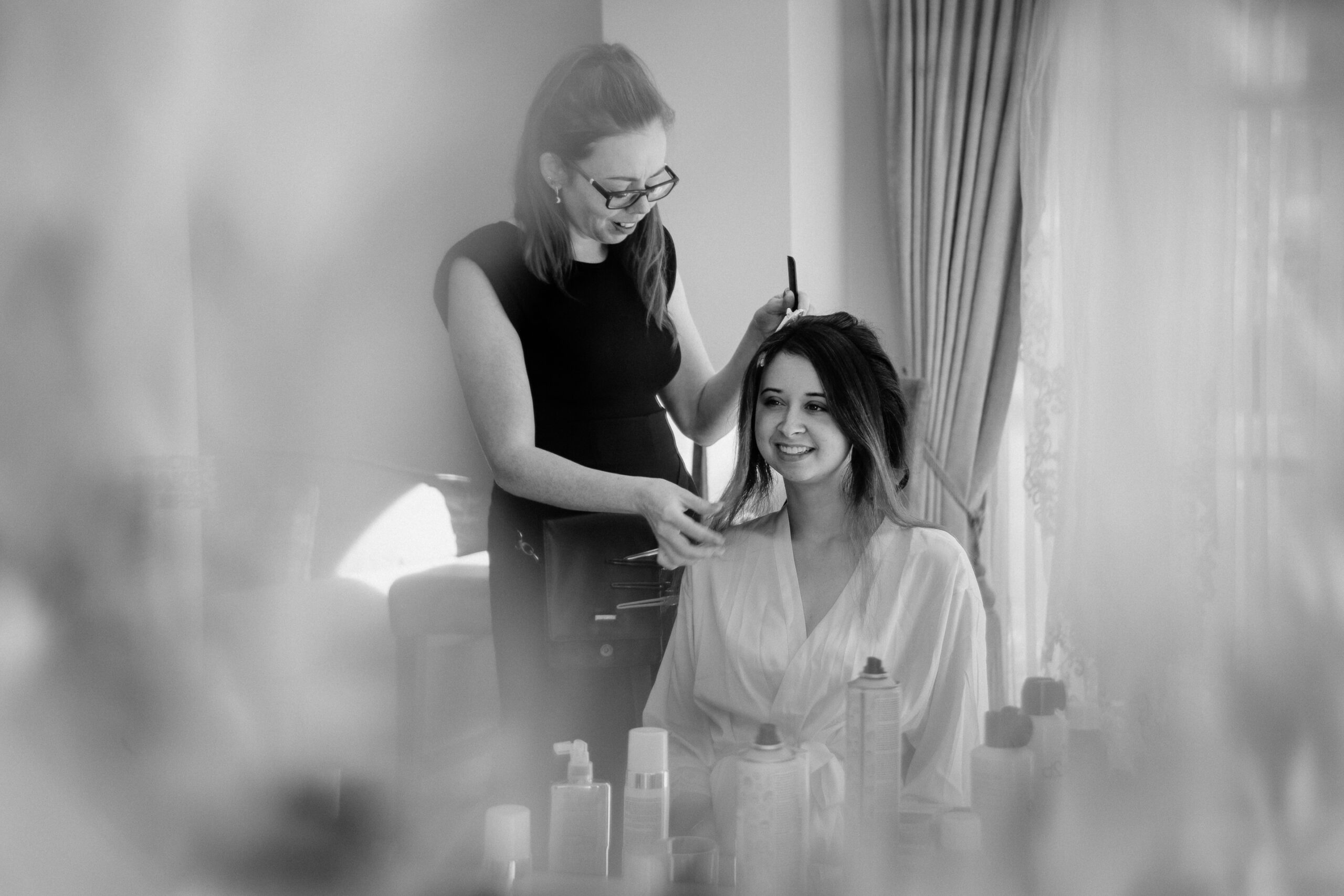 A woman cutting another woman's hair