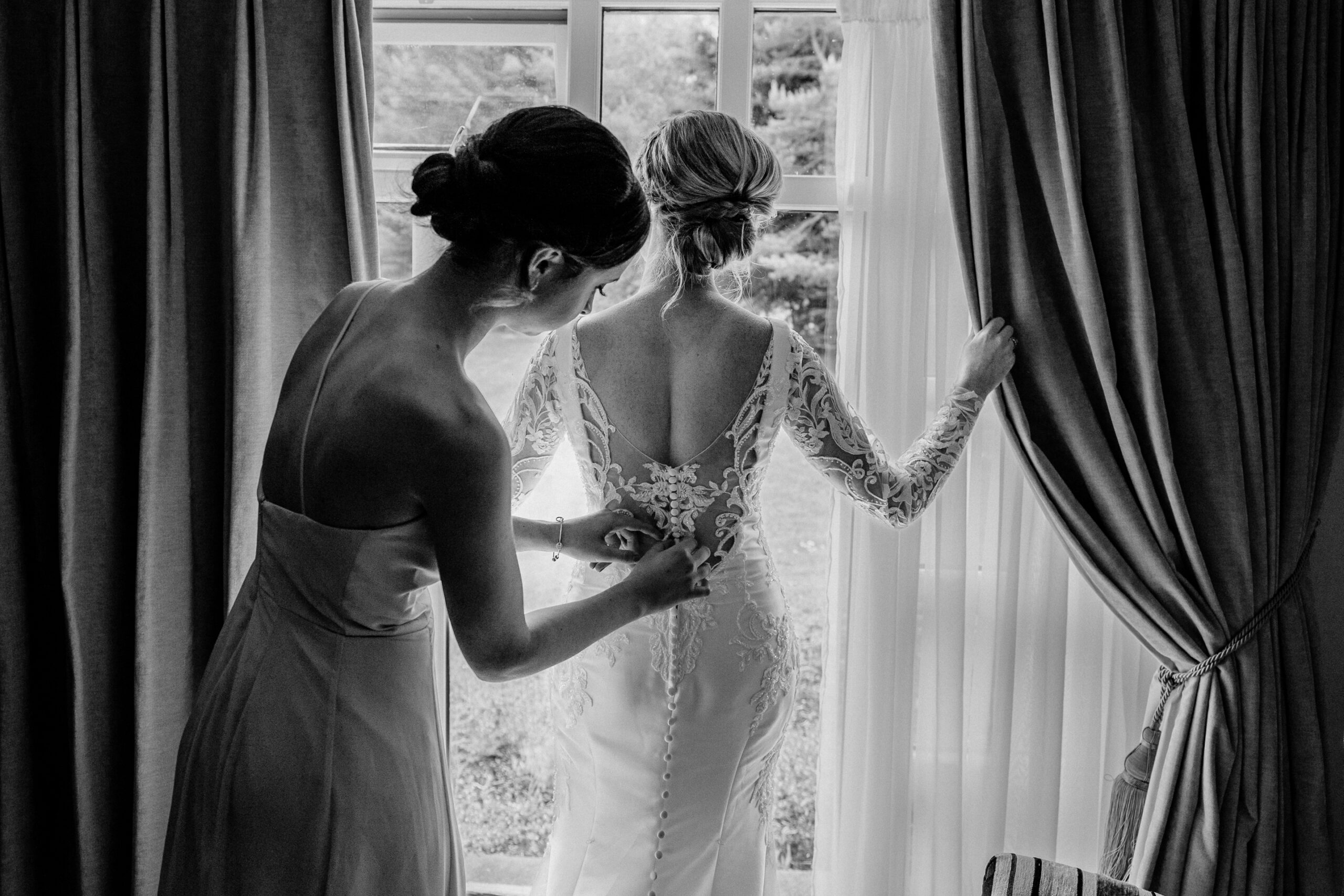 A person in a wedding dress kissing another woman in a dress