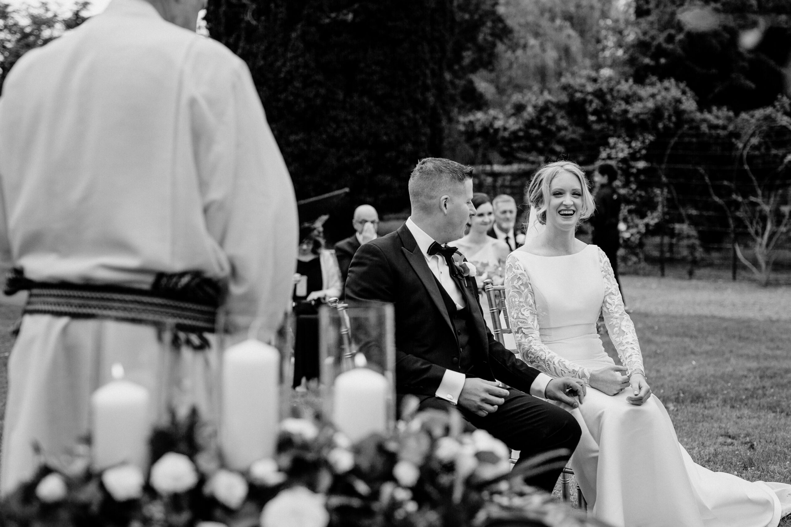 A man and woman sitting in a chair in front of a crowd