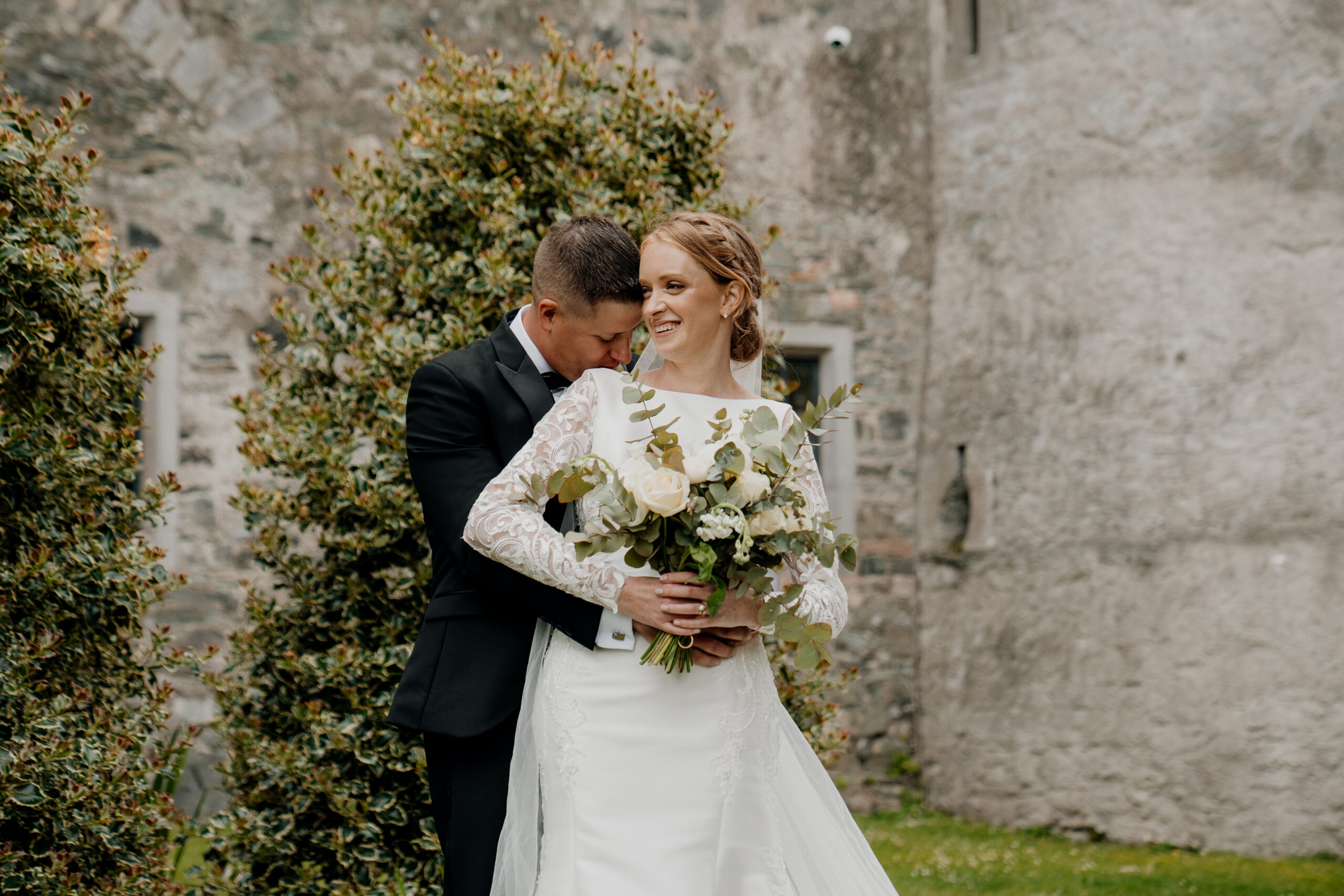 A man and woman holding flowers