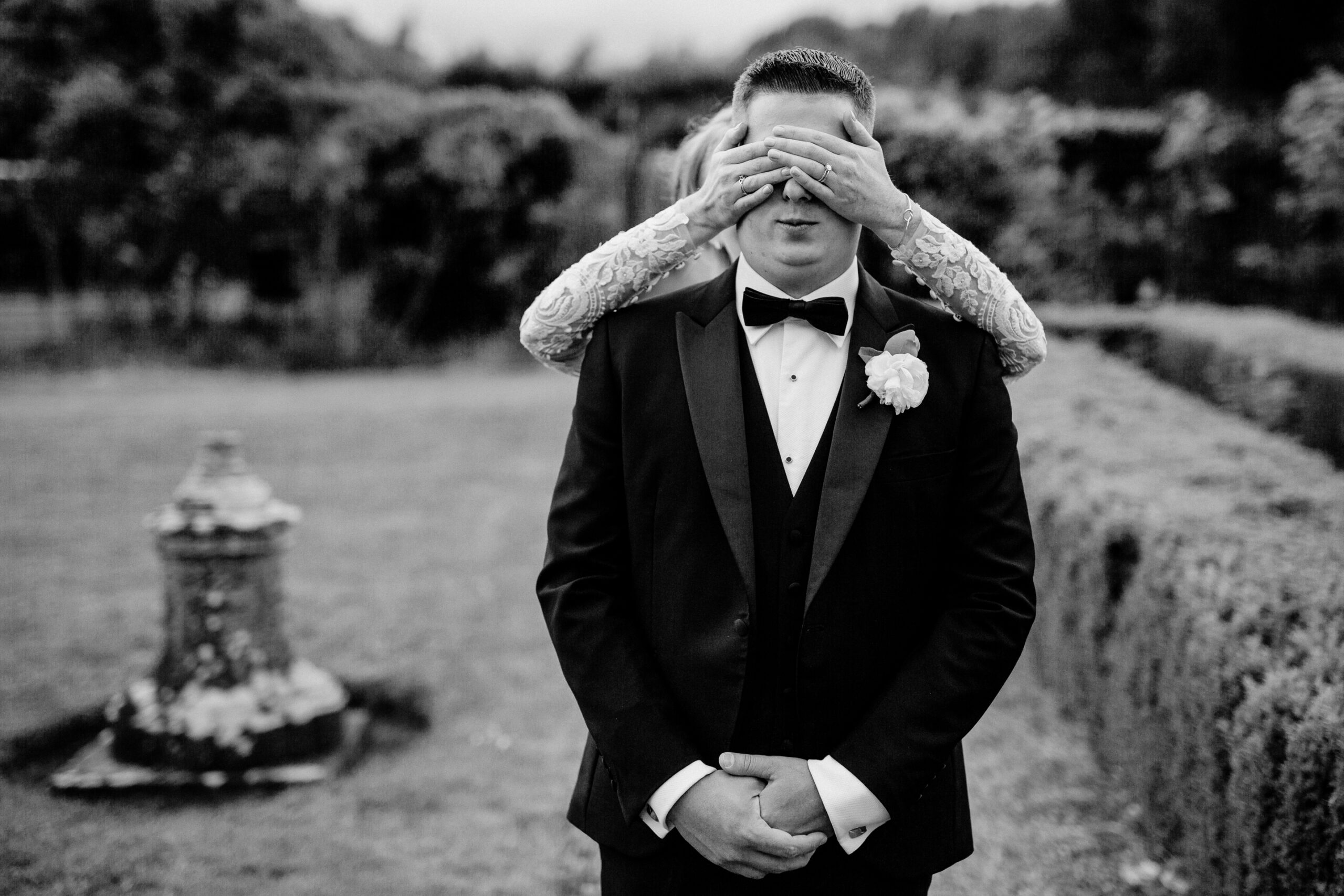 A person in a tuxedo holding the face up