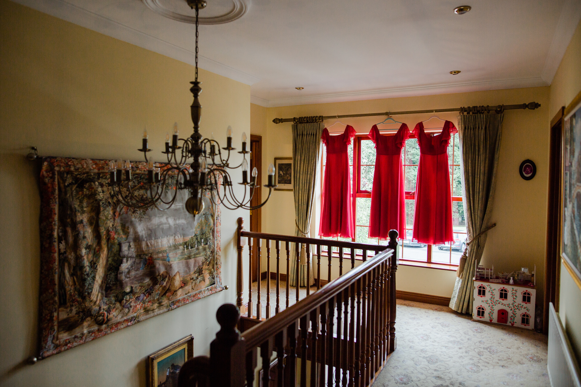 A room with a staircase and curtains