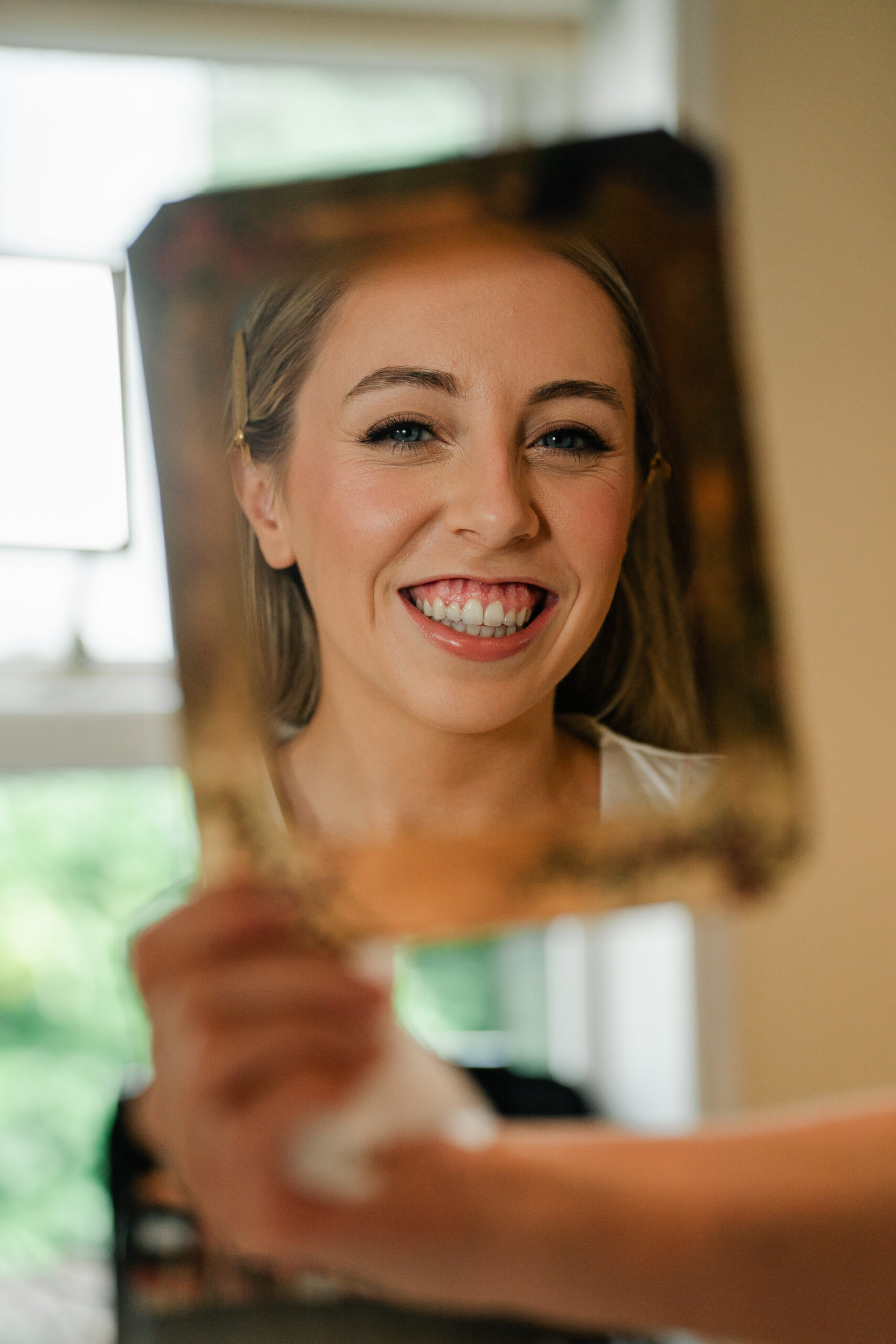 A woman smiling and pointing