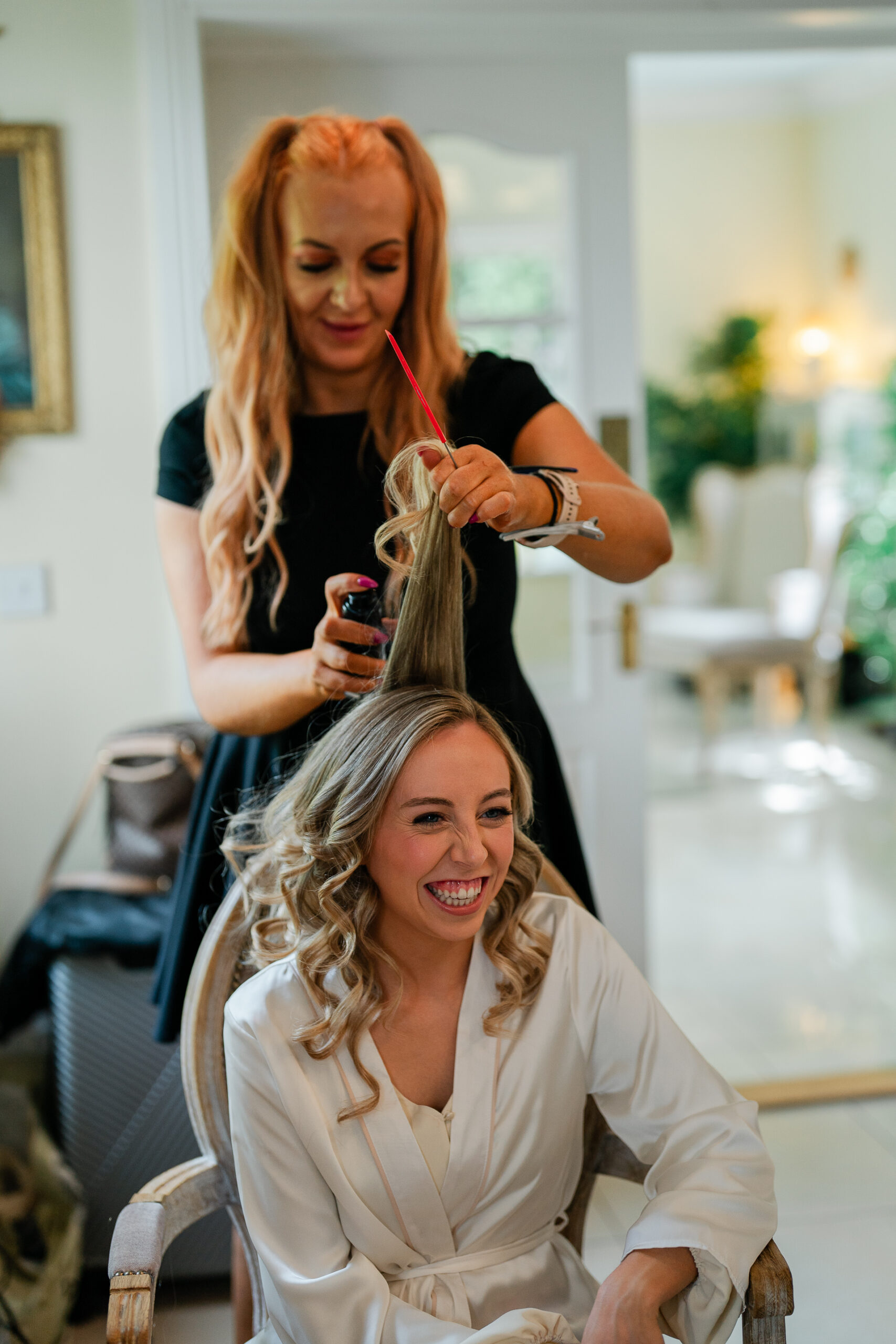 A woman cutting another woman's hair