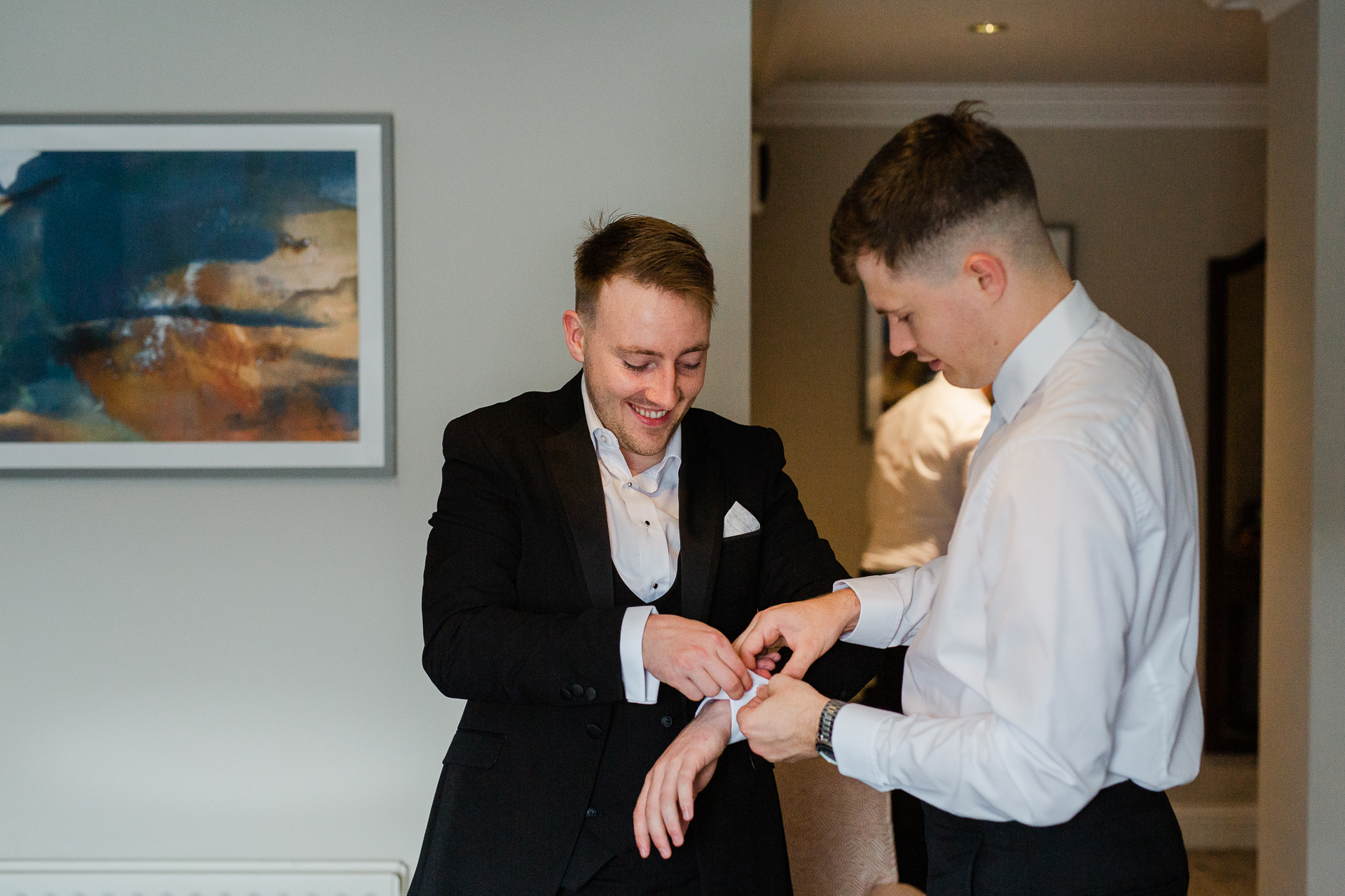 A man in a suit shaking hands with another man in a suit