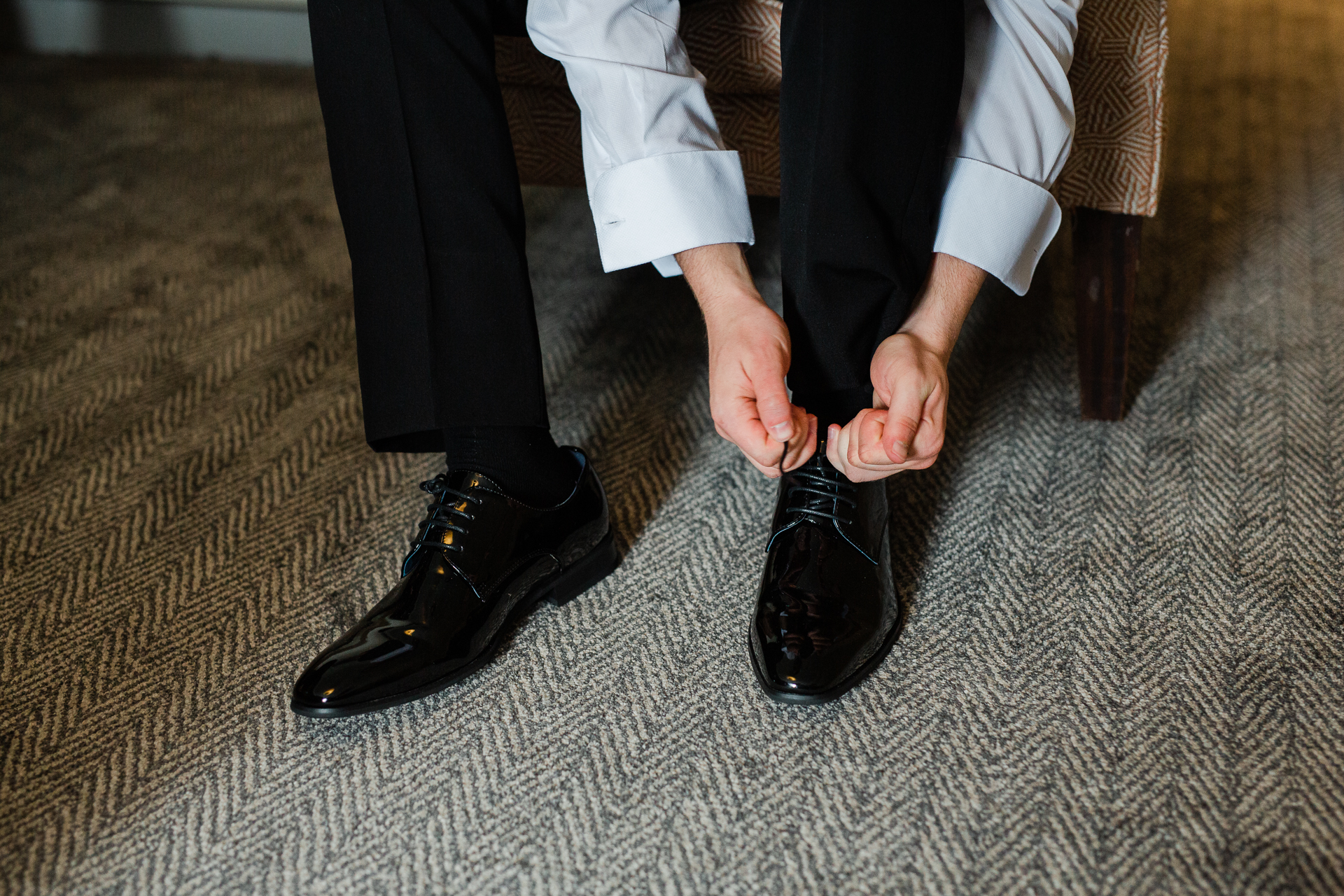 A pair of feet in black shoes