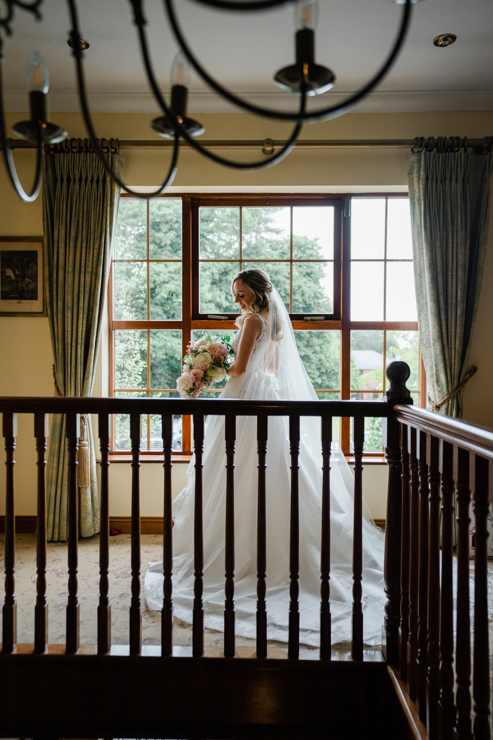 A person in a wedding dress standing on a balcony