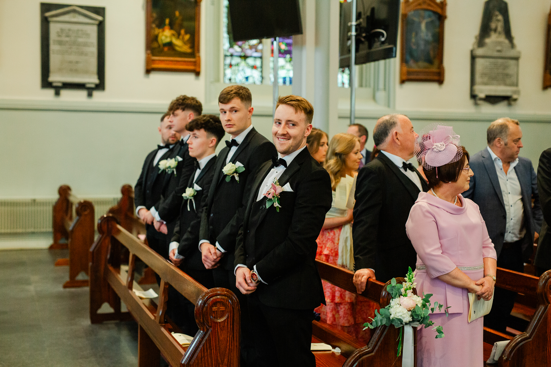 A group of people standing around a person in a suit and tie