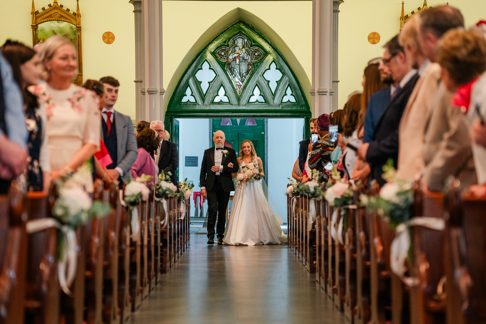 A bride and groom walking down the aisle