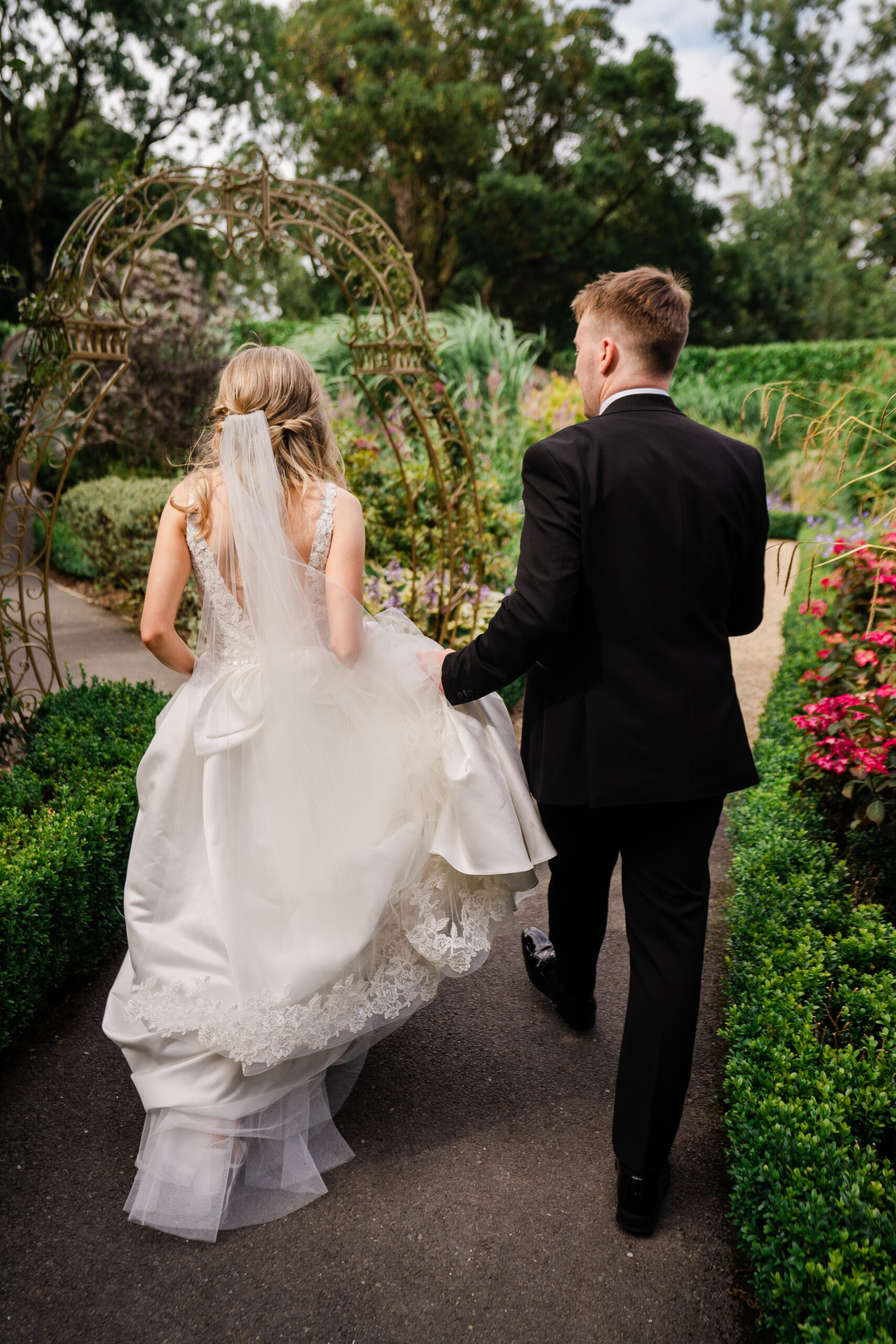 A man and woman walking down a sidewalk