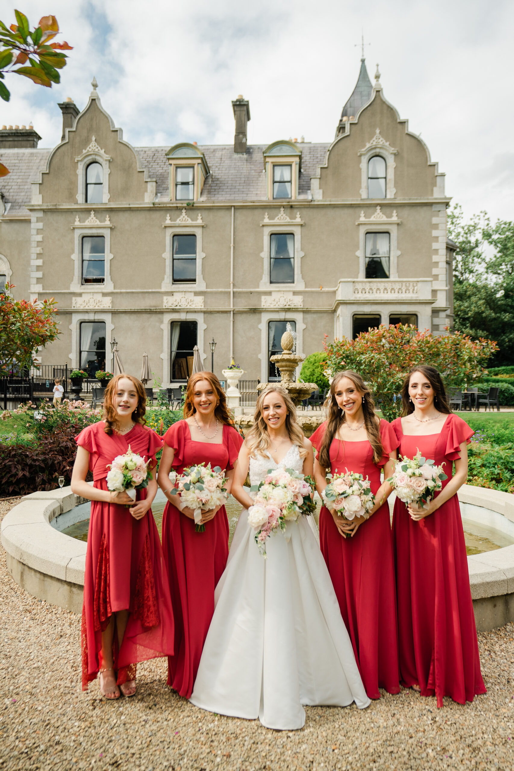 A group of women posing for a photo in front of a building