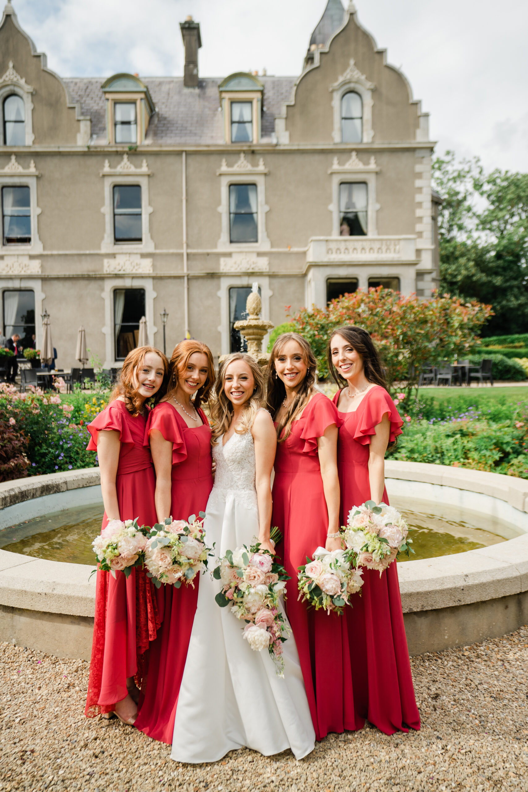 A group of women posing for a photo in front of a building