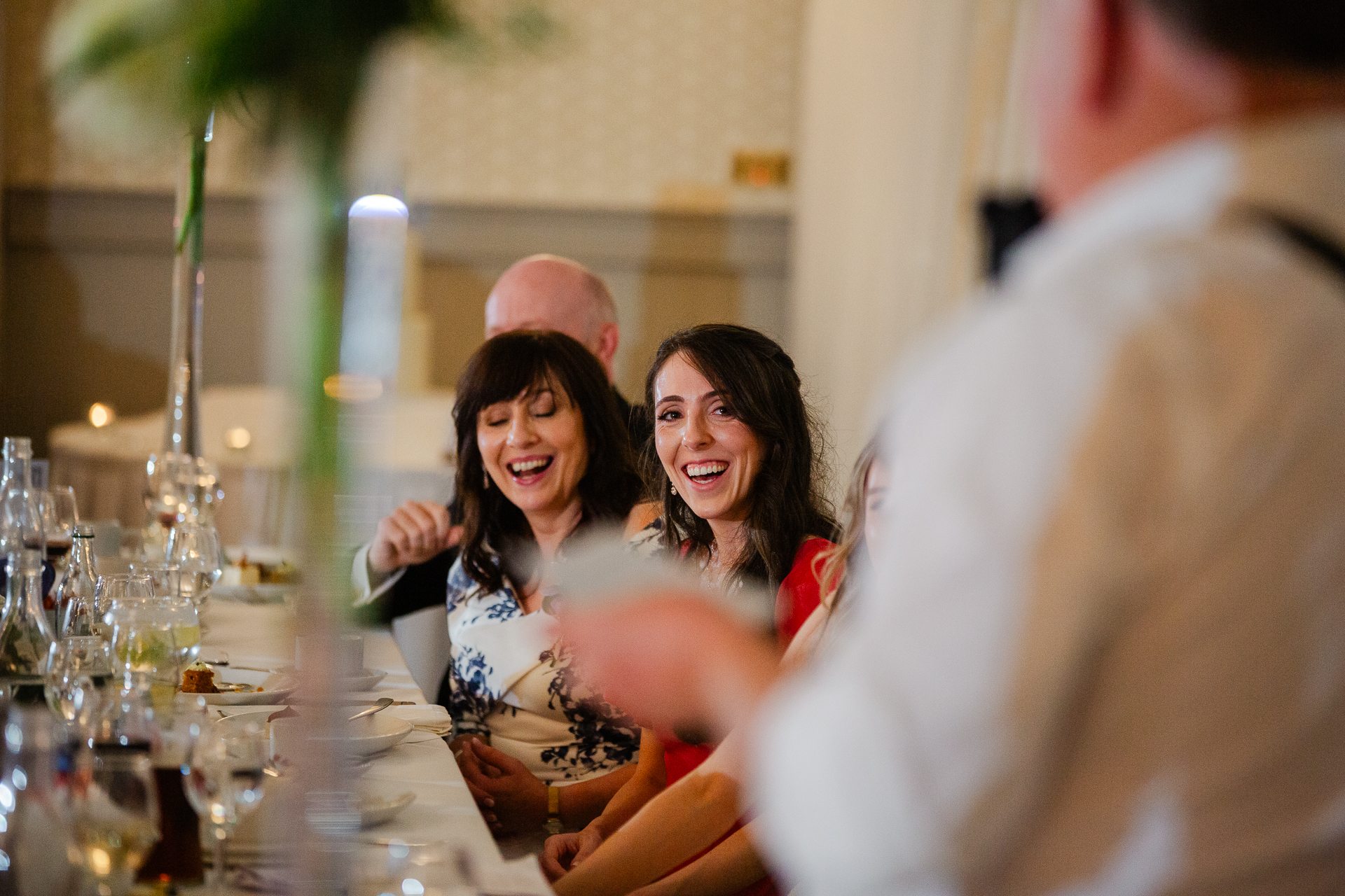 A group of people sitting at a table with wine glasses