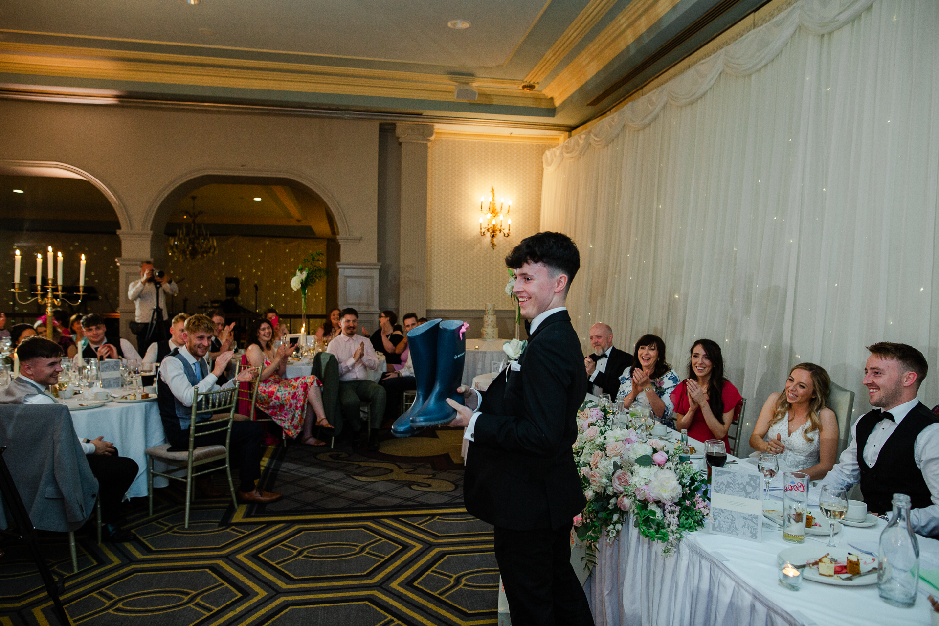 A person in a suit standing in front of a group of people