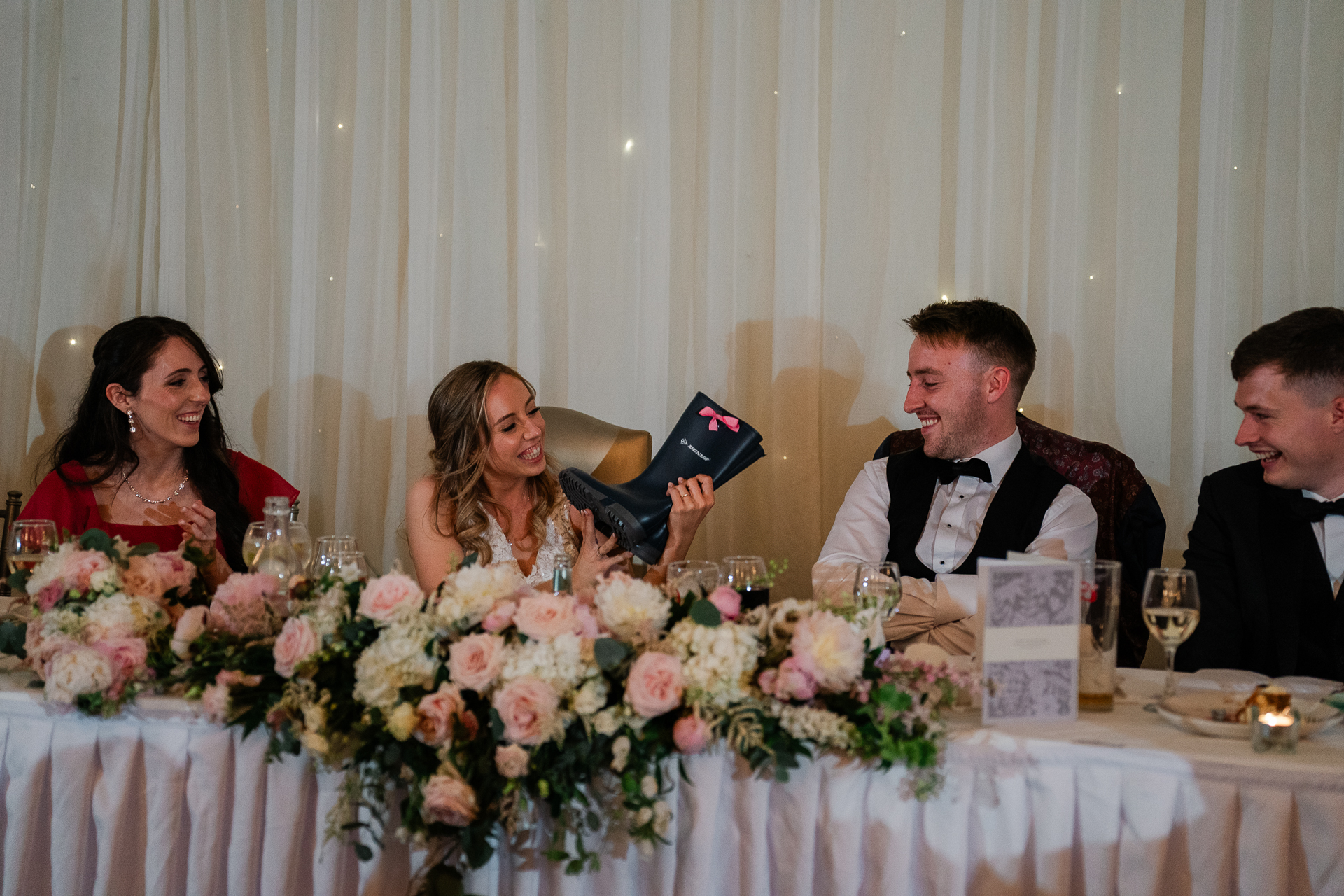 A group of people sitting at a table with flowers