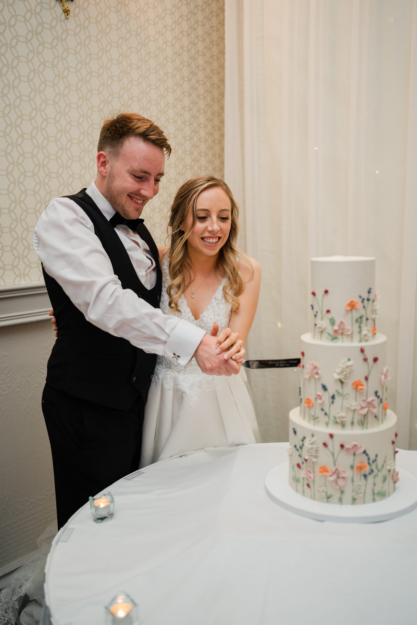 A bride and groom cutting a wedding cake