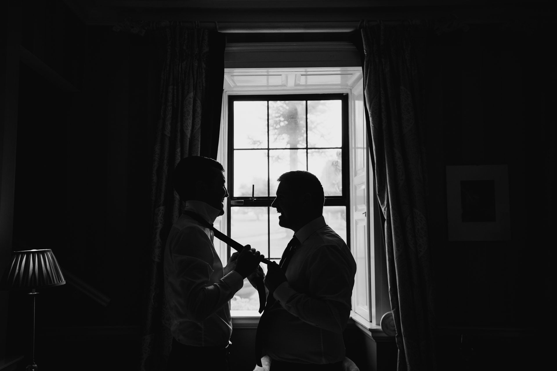 A man and woman holding guns in a dark room