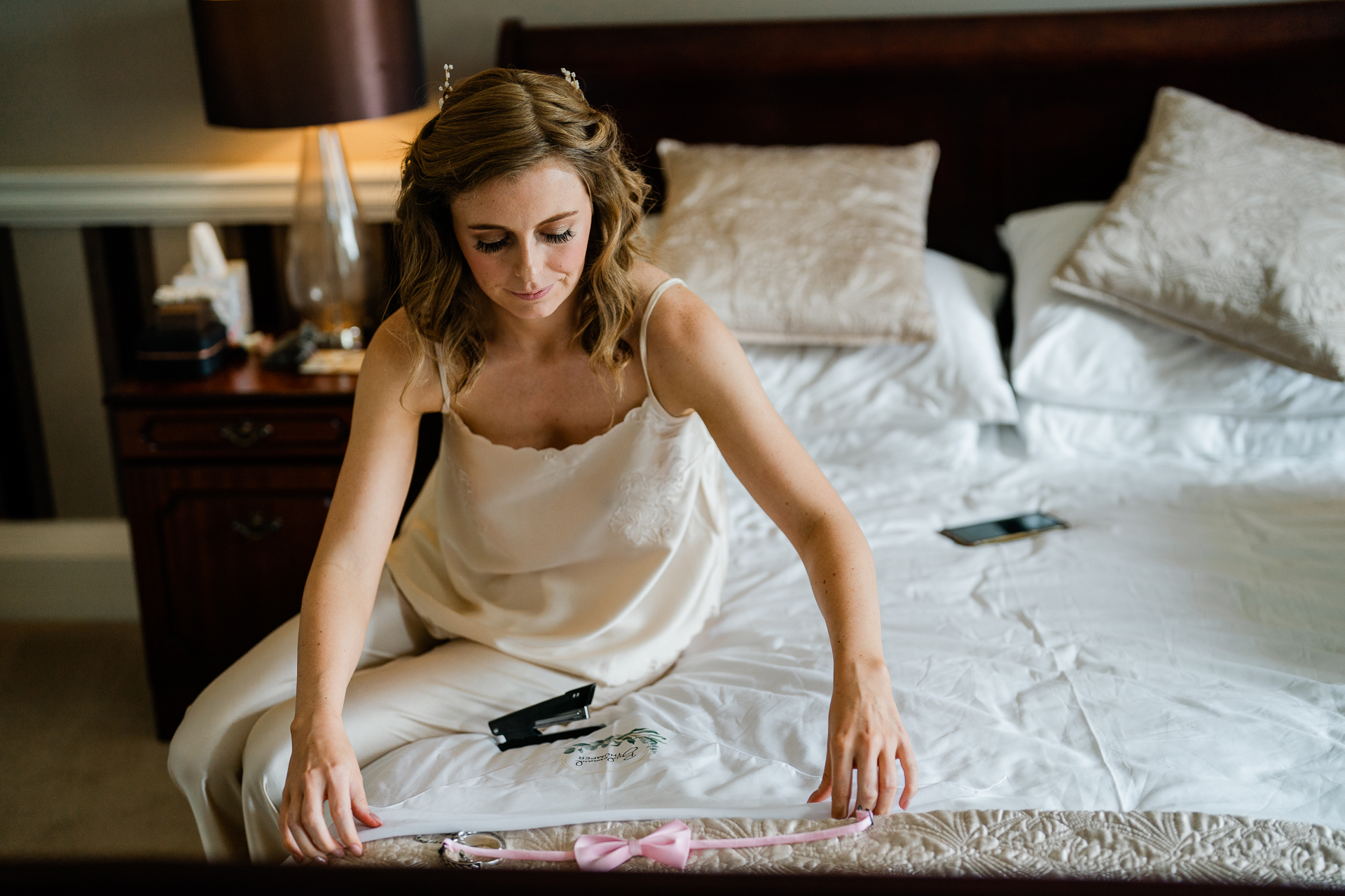 A person in a white dress sitting on a bed