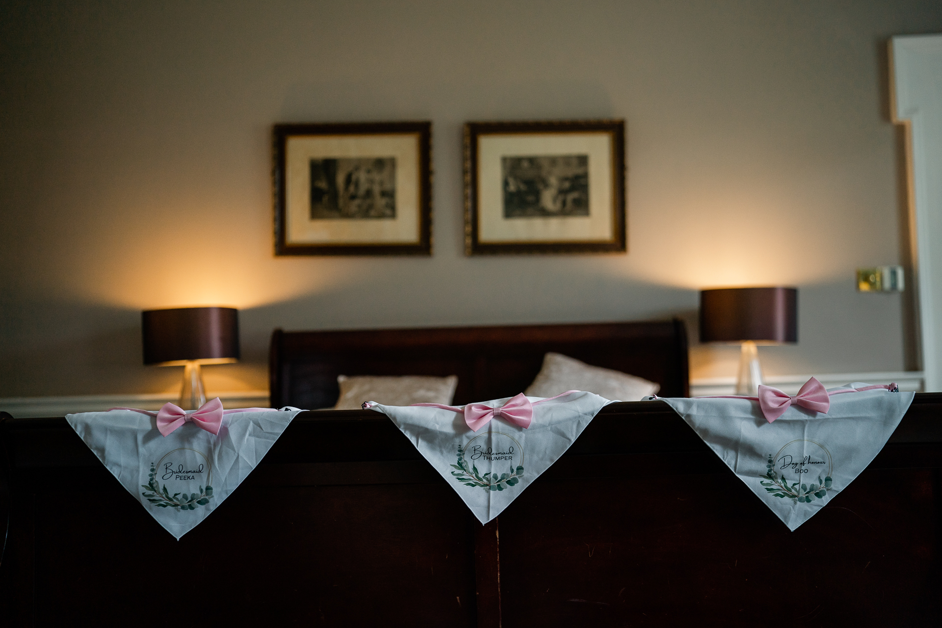 A bed with a couple of white sheets and a pink bow on it