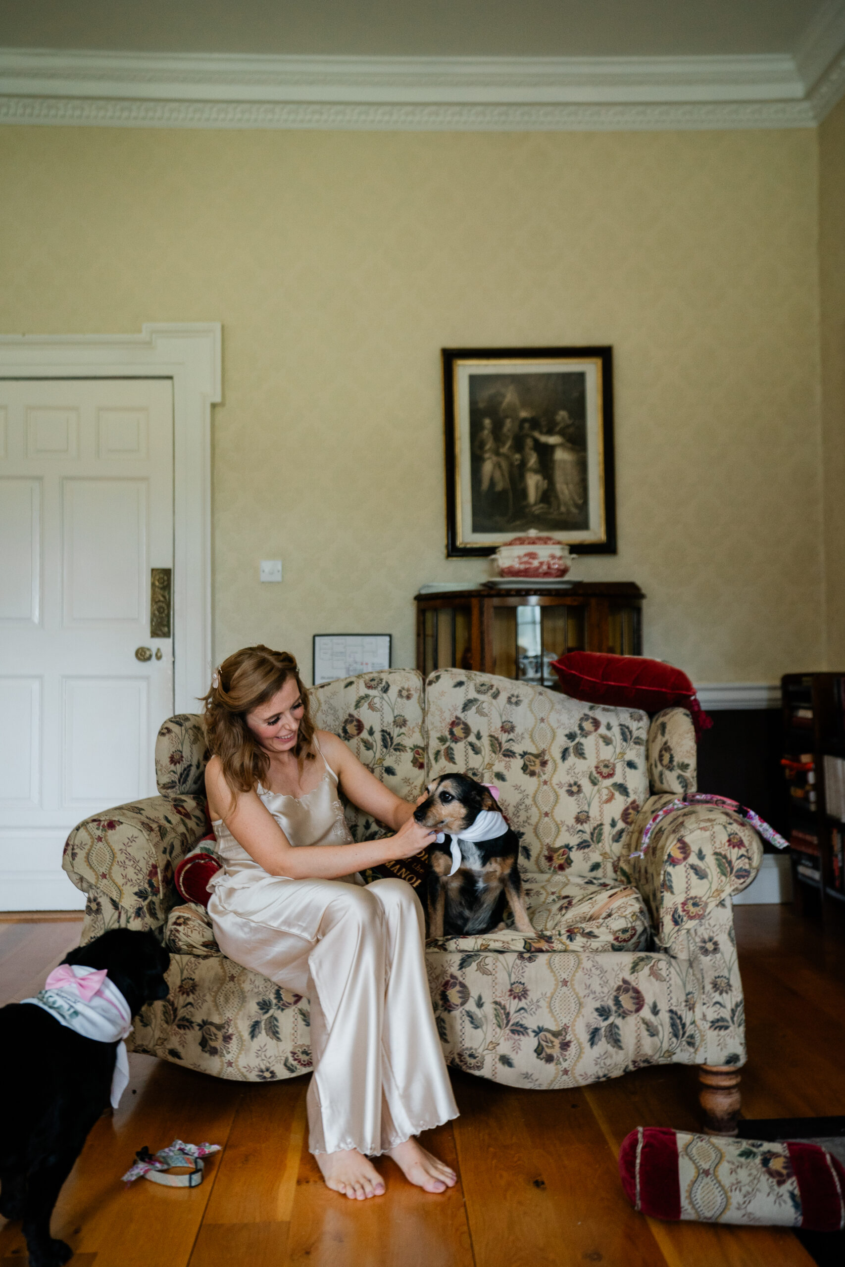 A person sitting on a couch with a dog