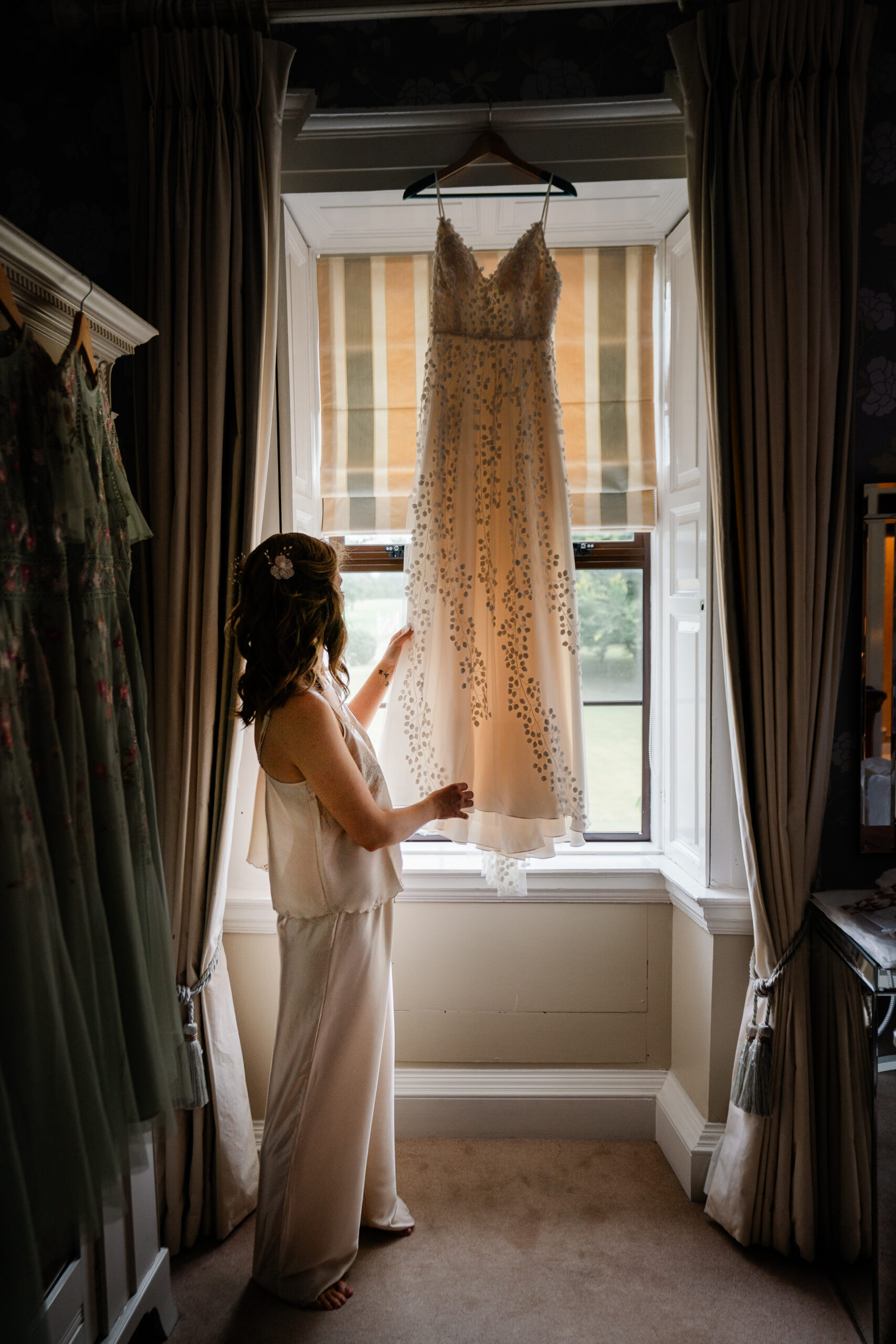 A person in a dress in a room with curtains