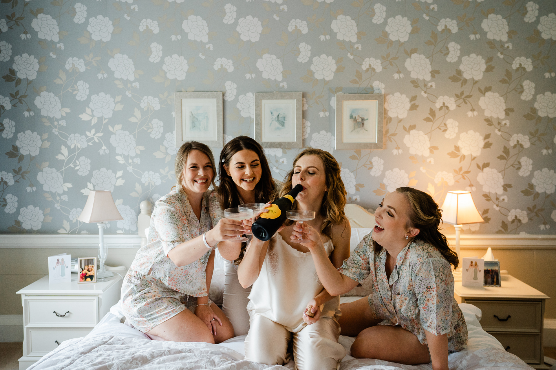 A group of women sitting on a bed