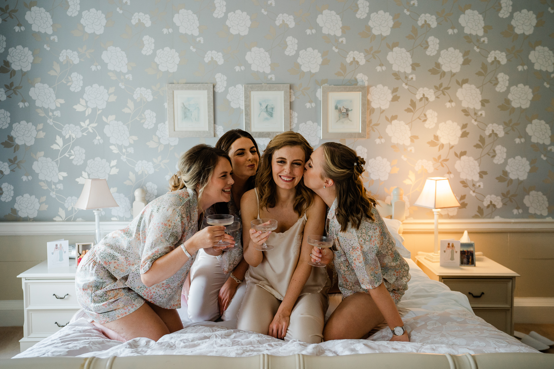 A group of women sitting on a bed