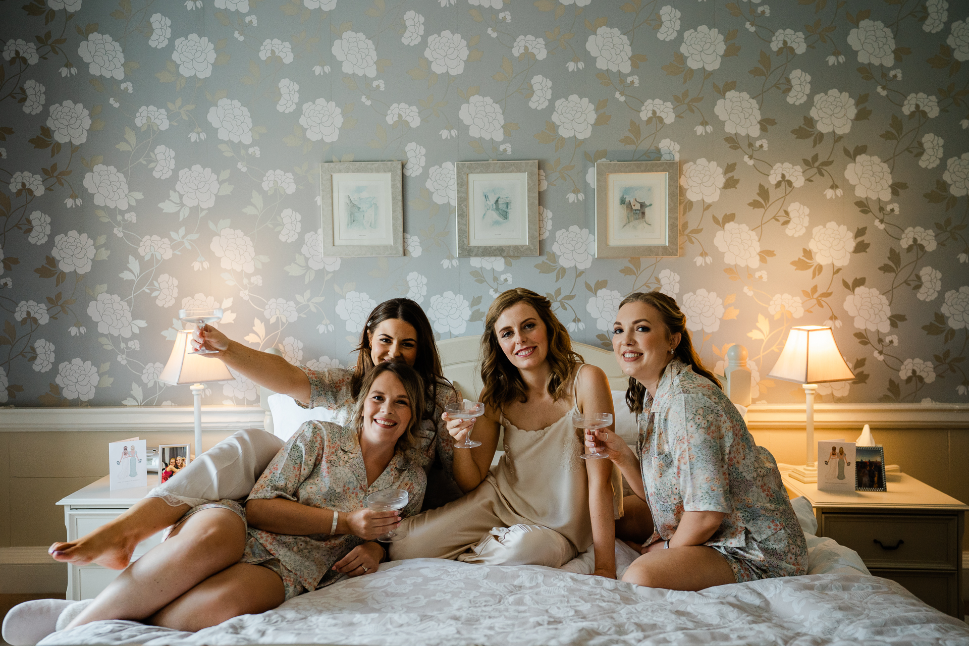 A group of women sitting on a bed