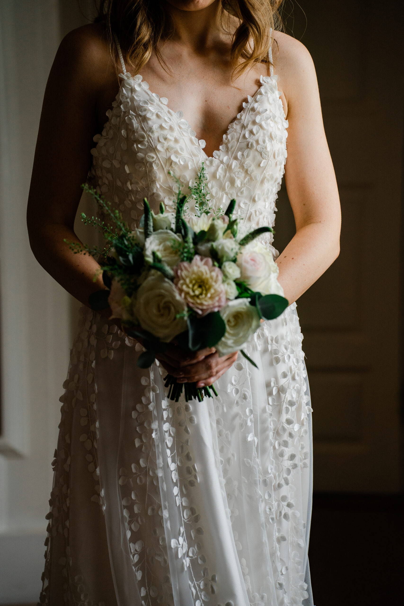 A woman wearing a white dress with flowers in her hair