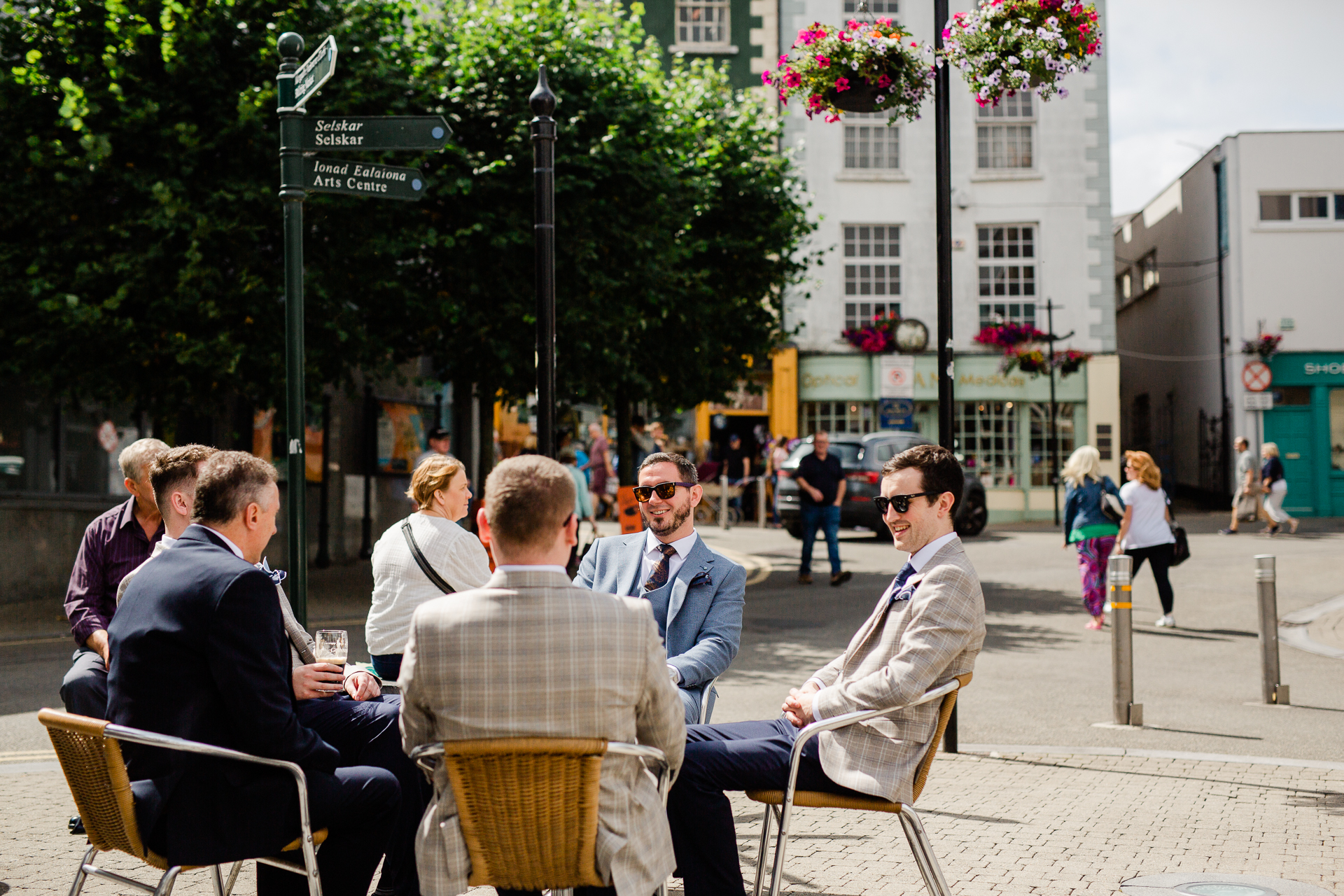 A group of people sitting at a table outside