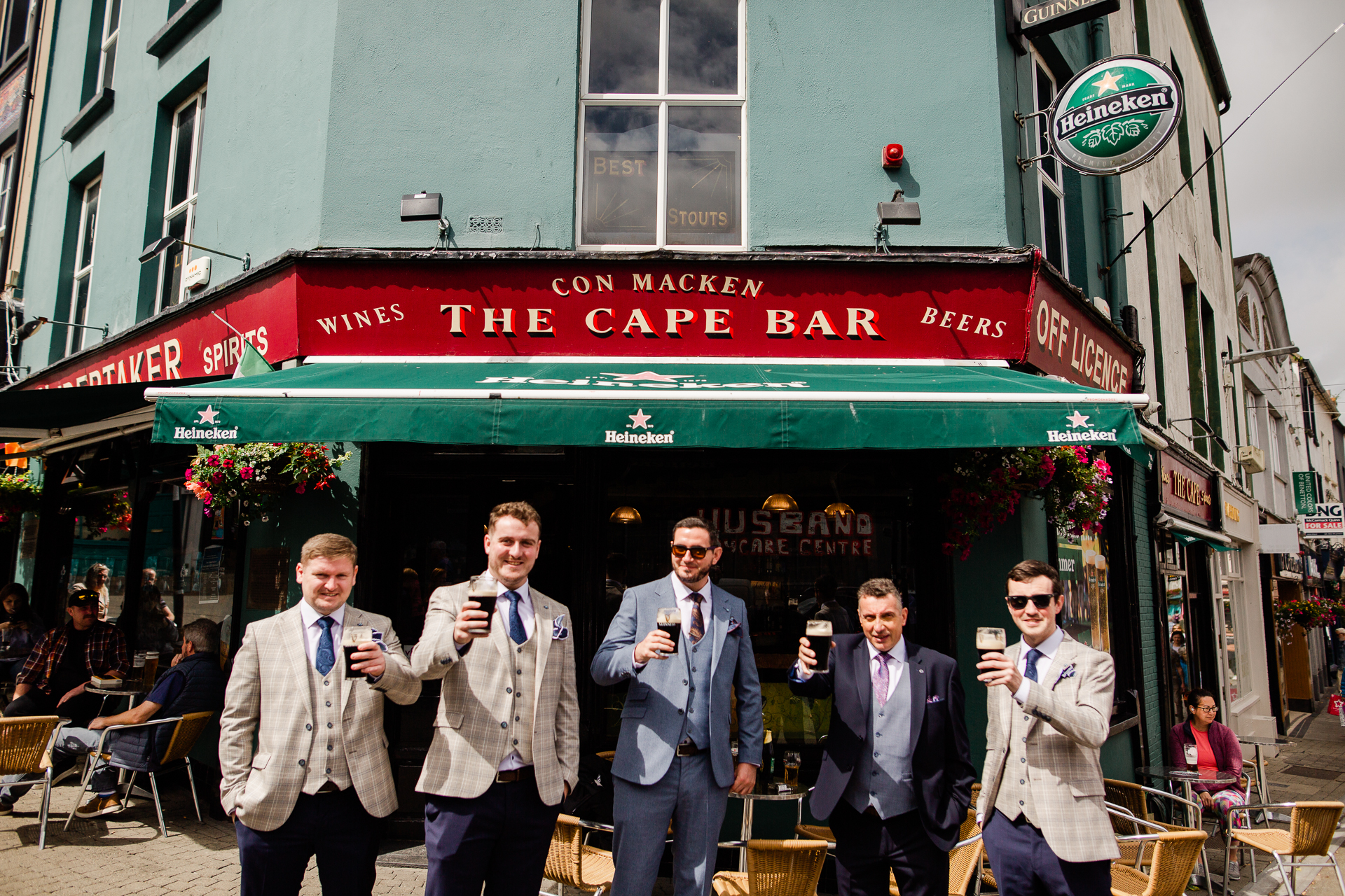 A group of men standing outside a restaurant