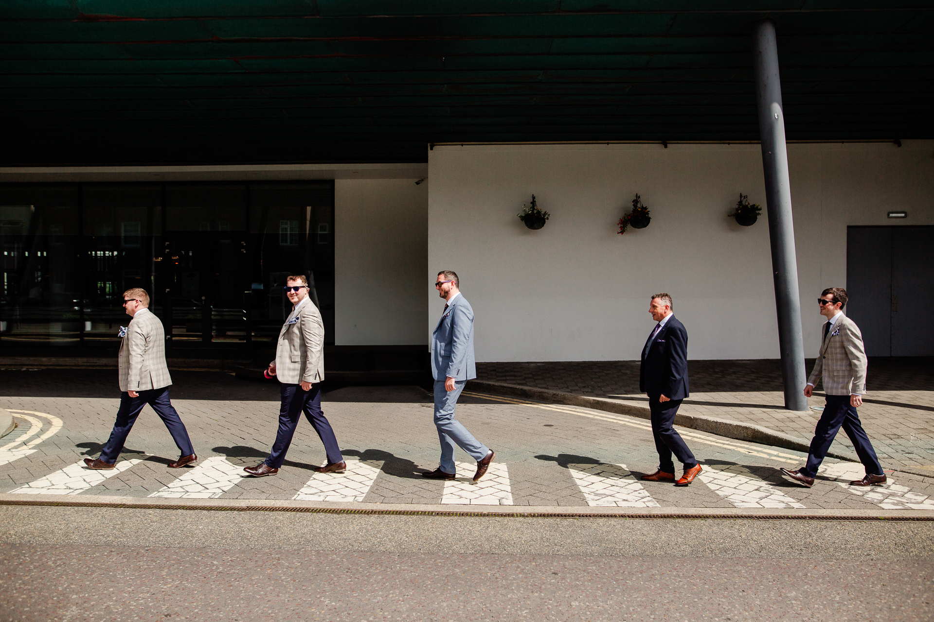 A group of men walking across a crosswalk