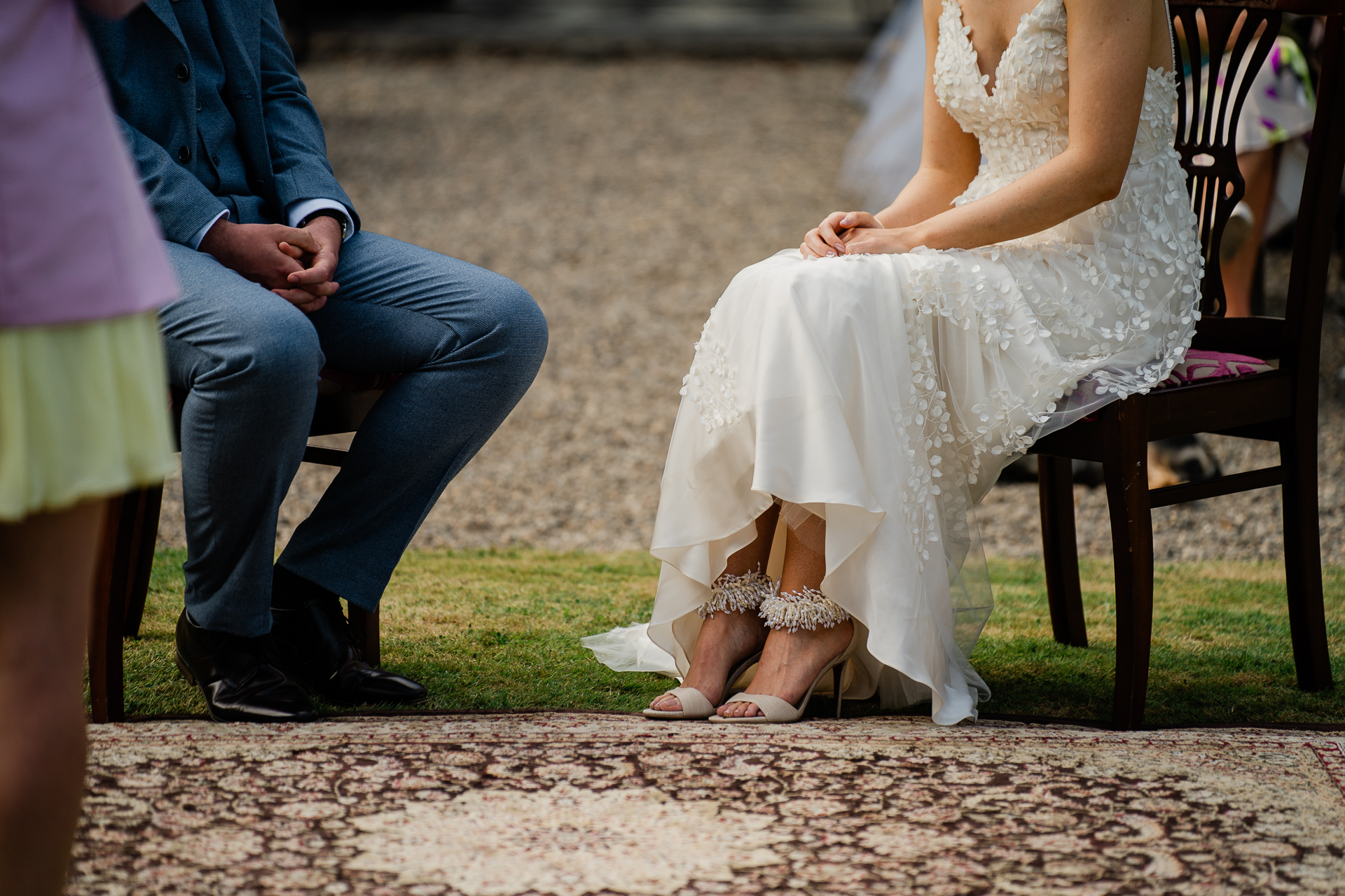 A woman in a wedding dress sitting on a chair