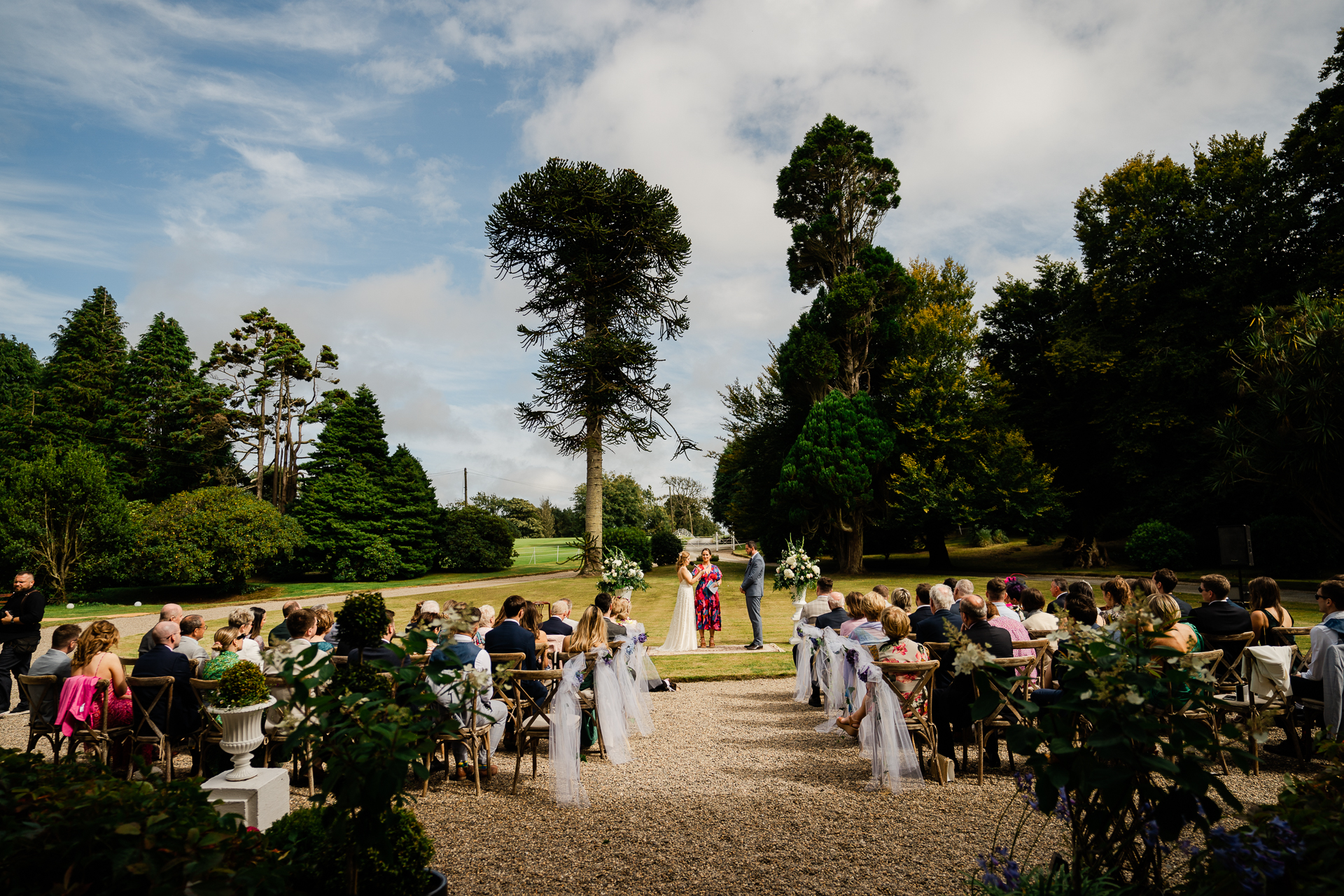 A group of people in white gowns and a crowd of people