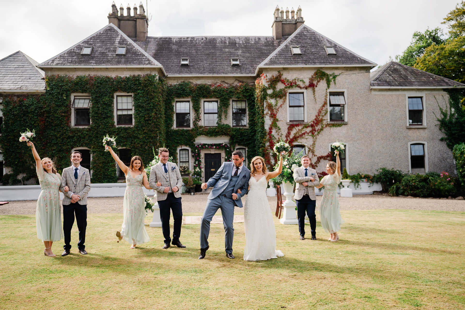 A group of people posing for a photo in front of a house