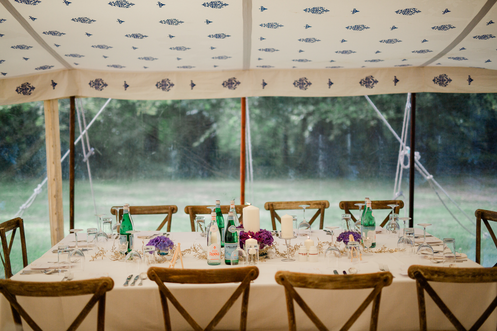 A table with chairs and bottles on it