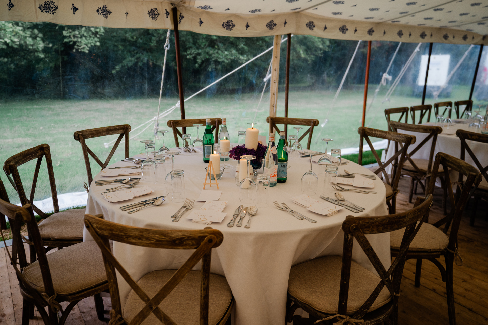 A table set with wine bottles and glasses on it