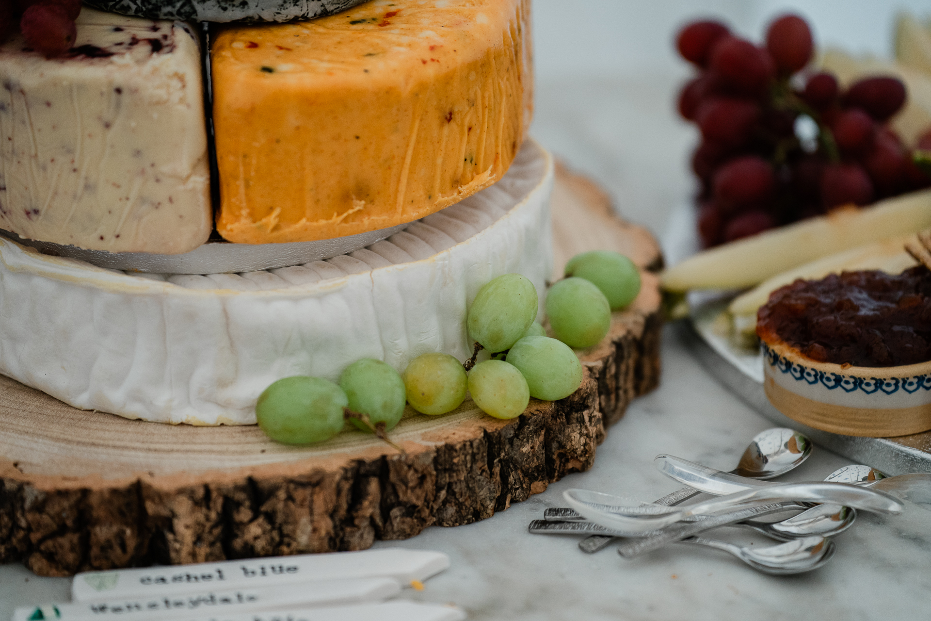 A cake with grapes and a slice cut out