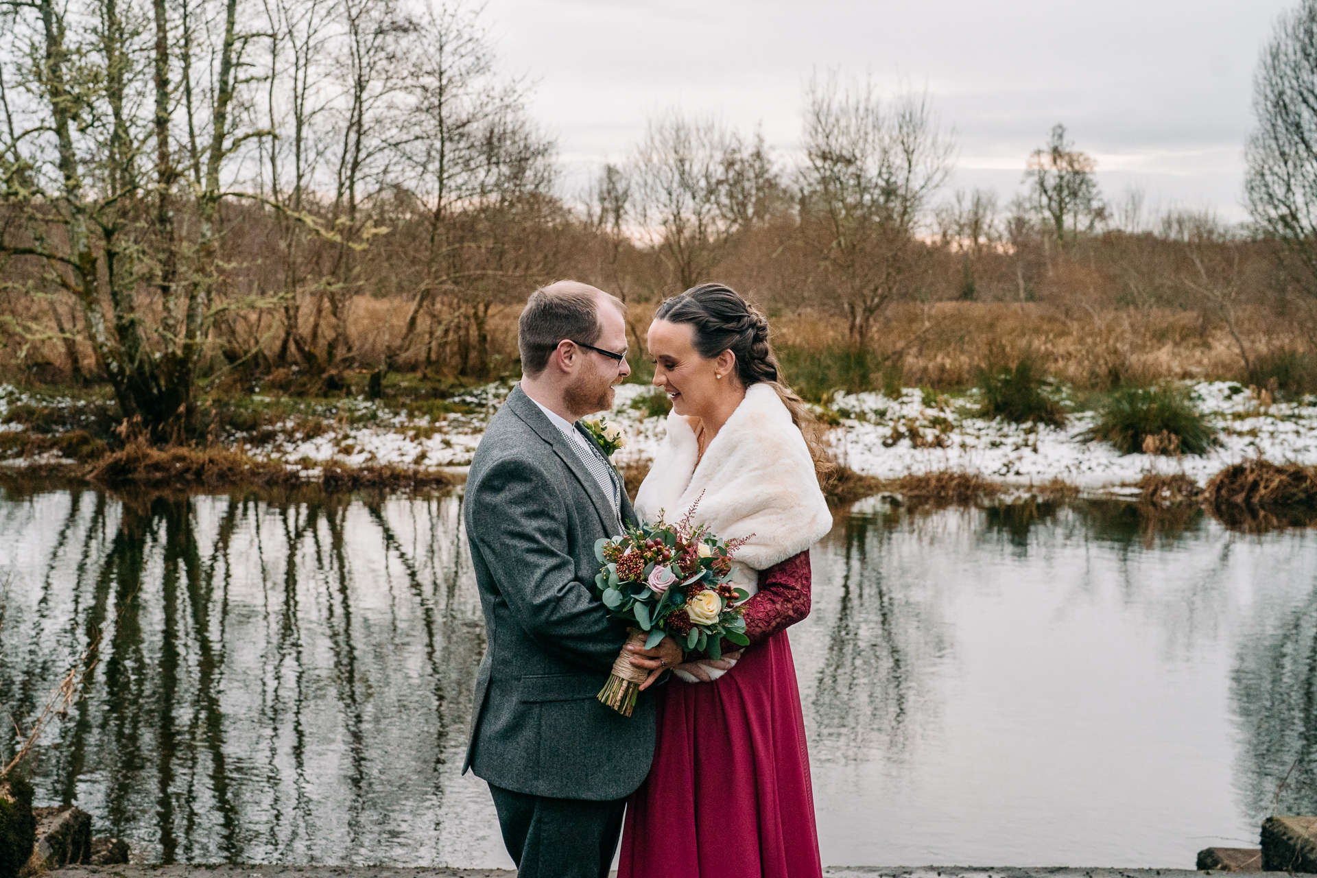 Newlywed couple by the lake during a winter wedding at Markree Castle