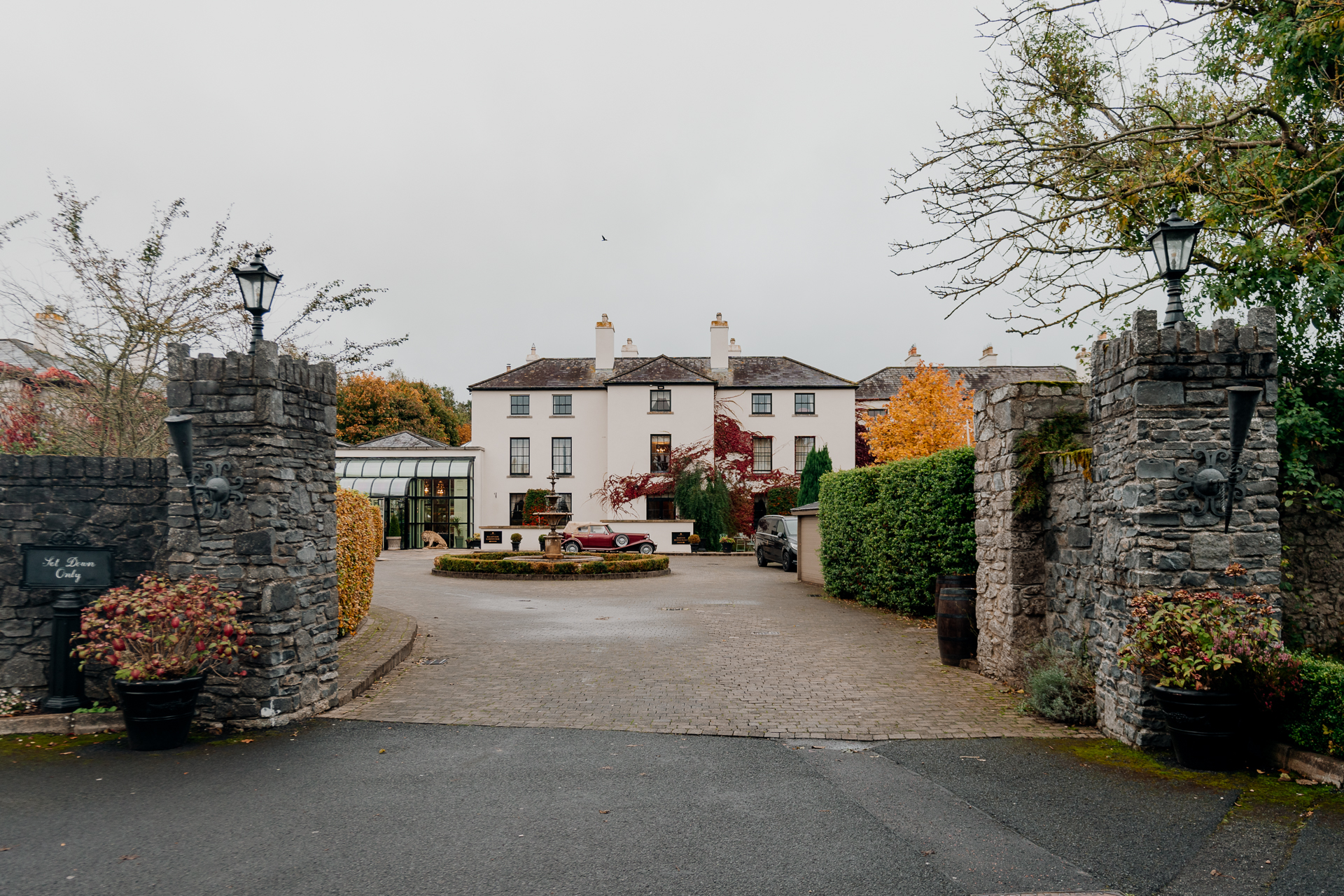 A road with a building on the side and a fence around it