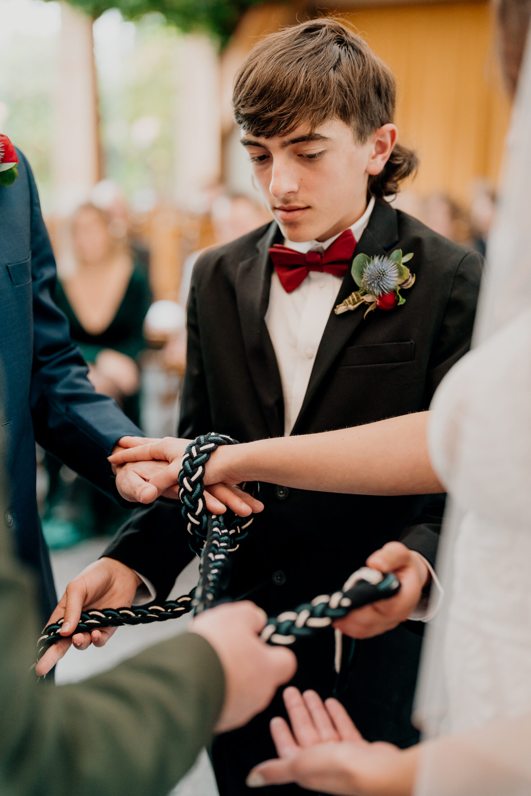 A person in a suit holding a snake