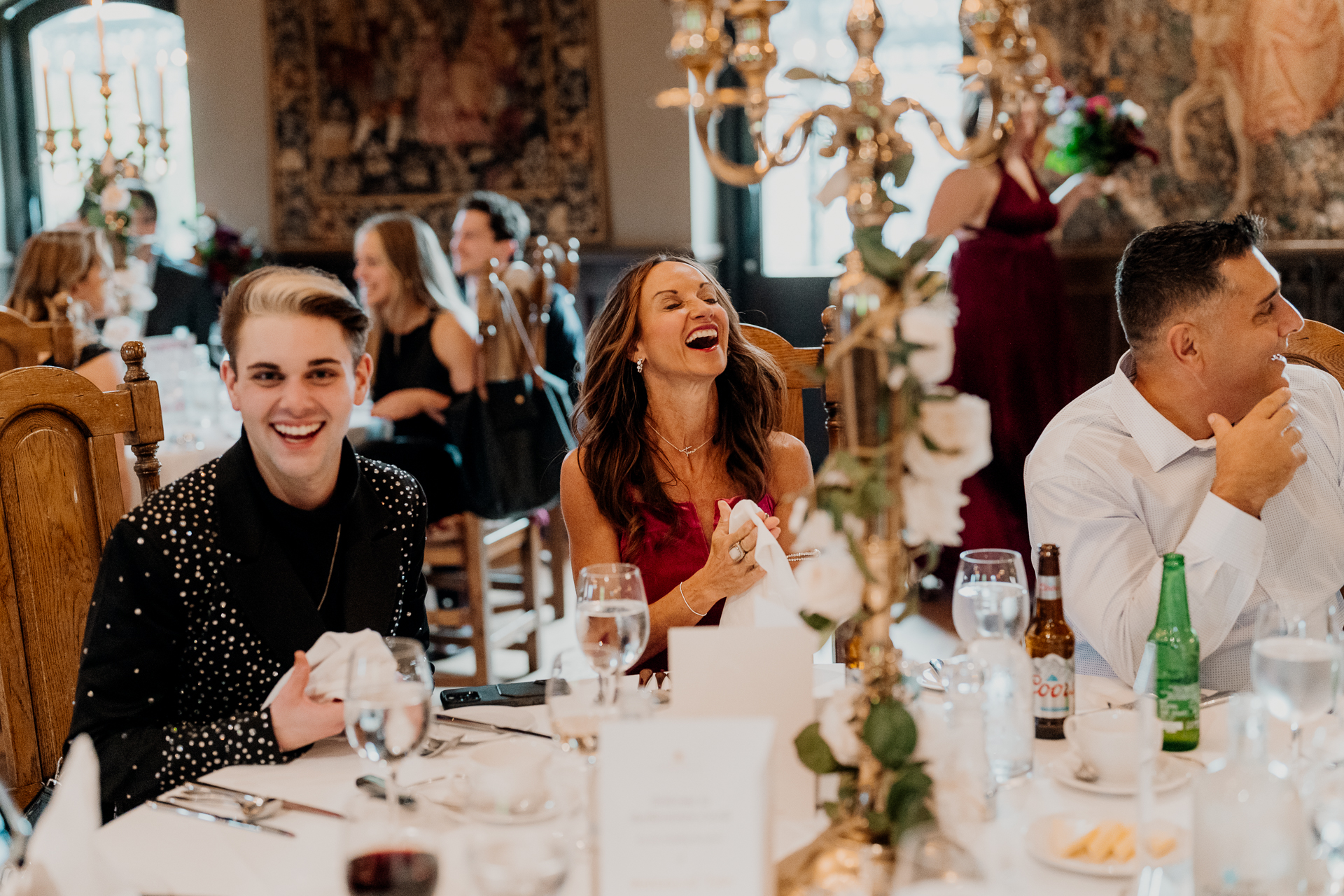 A group of people sitting at a table with food and drinks