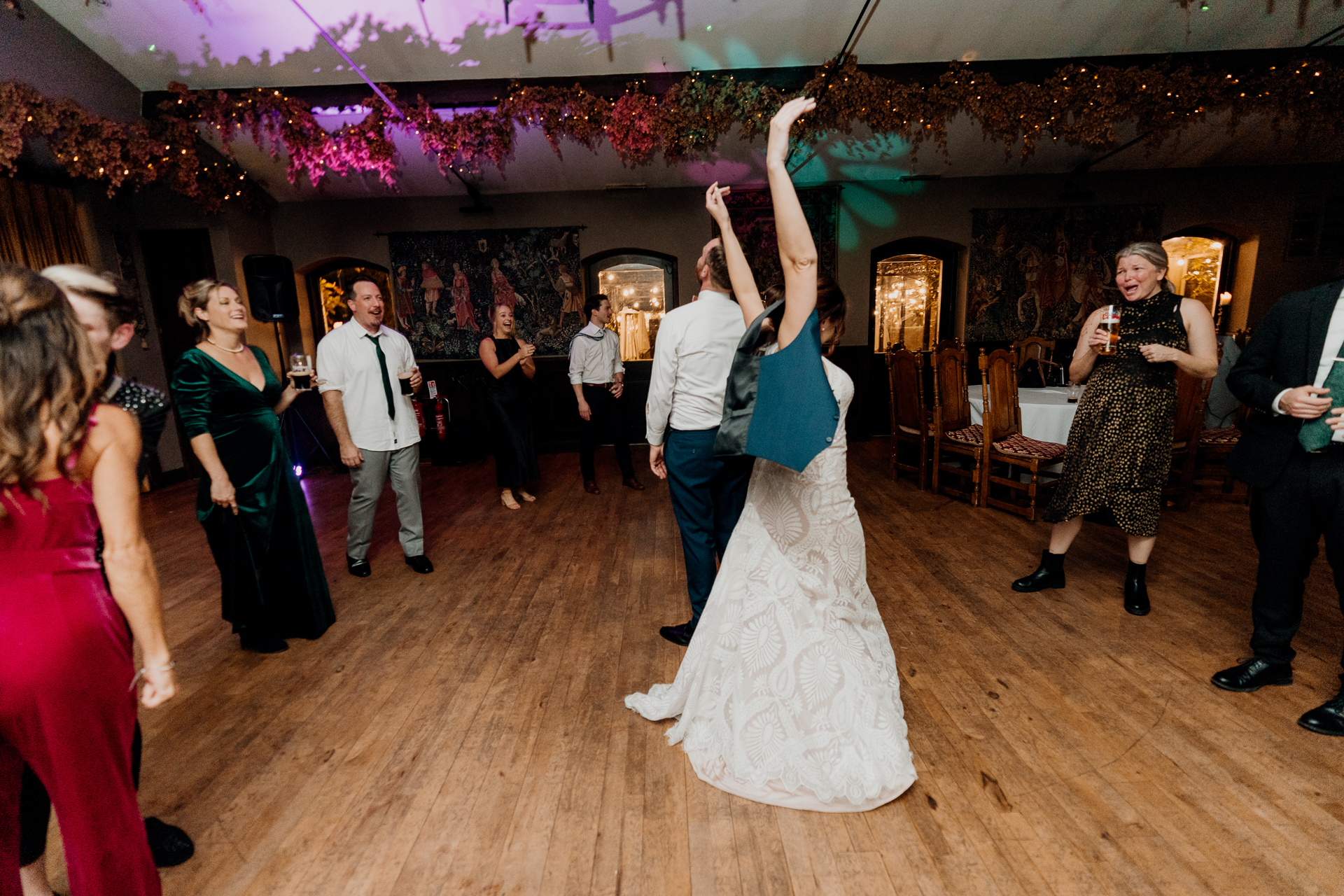 A man and woman dancing in a room with other people